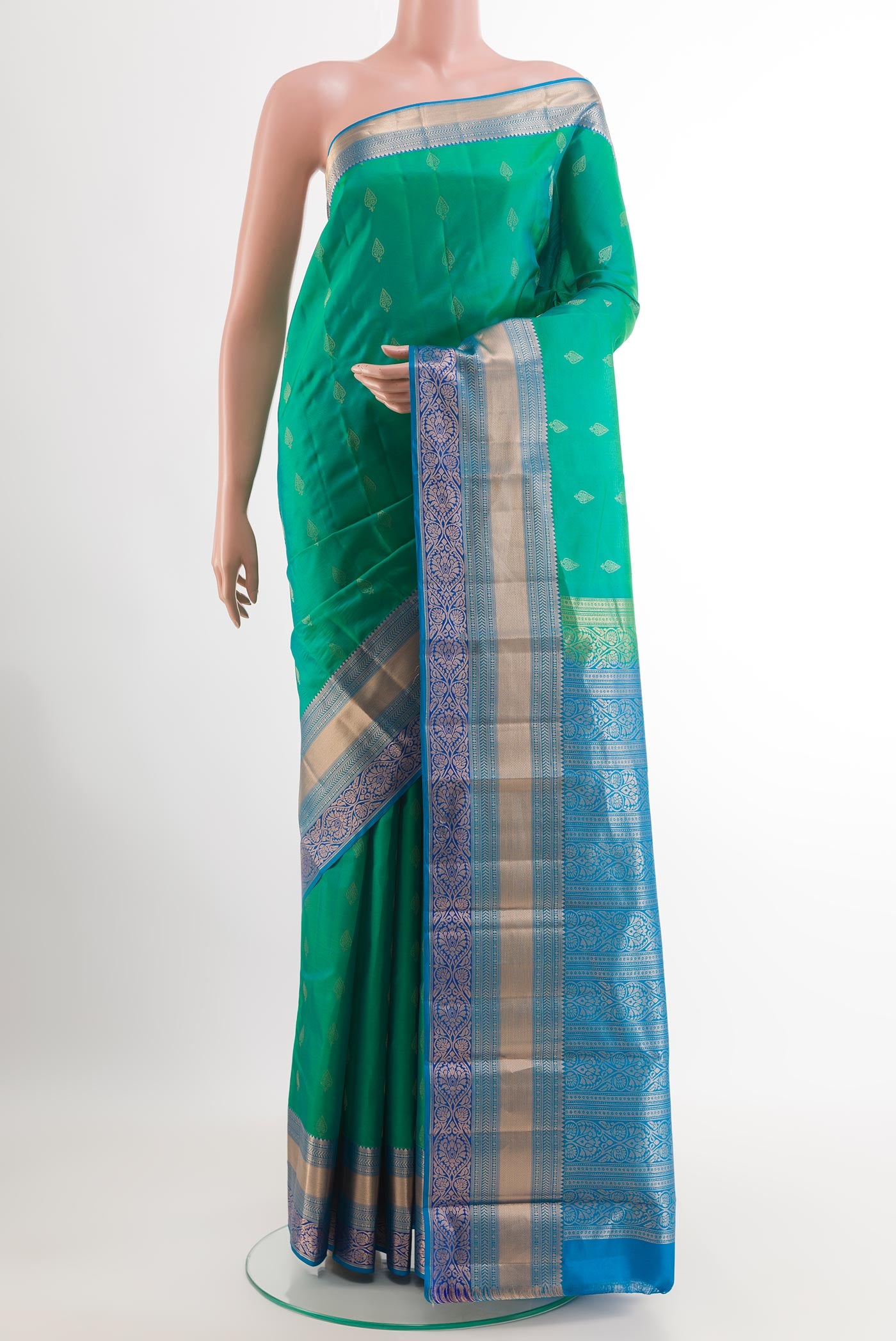 Sea Green Kanchipuram Silk Saree with Zari Butta on the body and Zari Border.  displayed on a mannequin