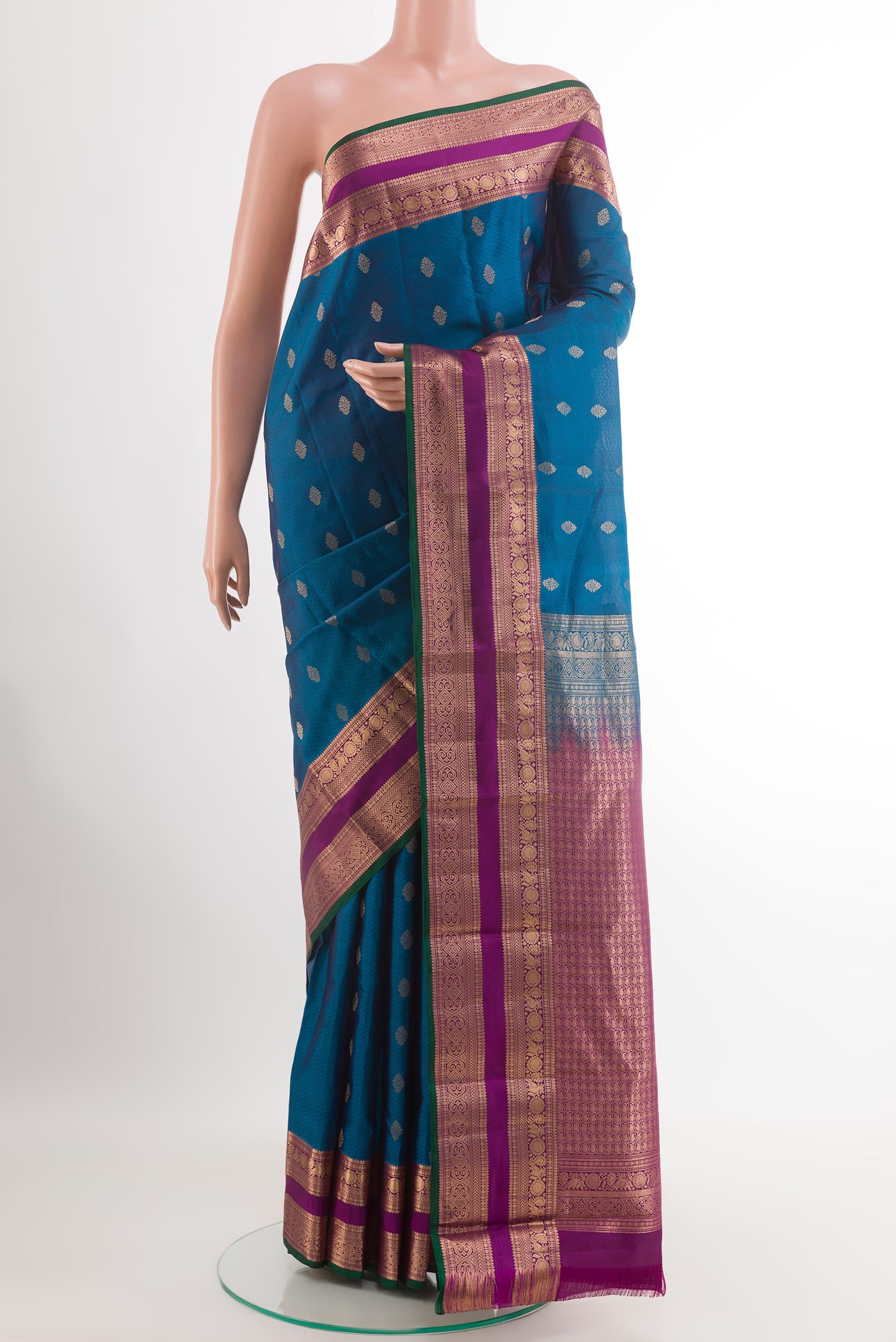 Peacock Blue Kanchipuram Silk Saree with Jacquard With Zari Butta on the body and Zari Border.  displayed on a mannequin