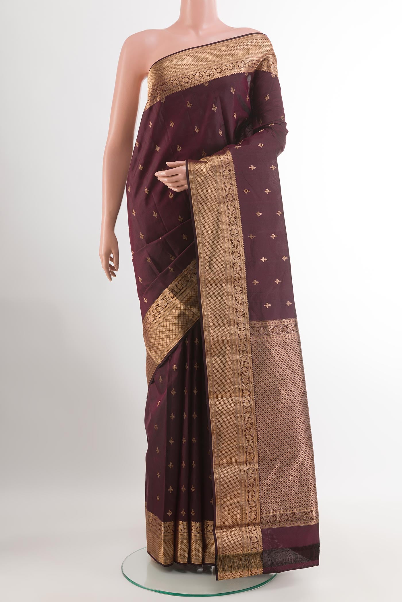 Purple Kanchipuram Silk Saree with Zari Butta on the body and Zari Border.  displayed on a mannequin