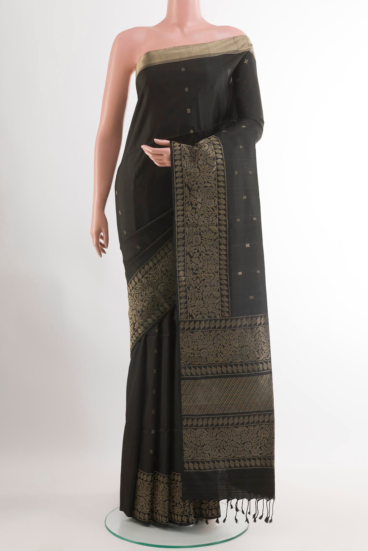 Black Soft Silk Saree with Zari Butta on the body and Zari Border.  displayed on a mannequin