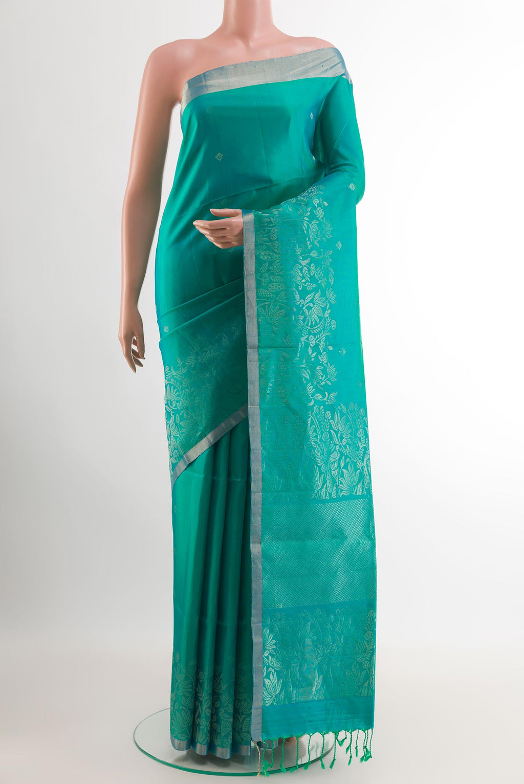 Sea Green Soft Silk Saree with Zari Butta on the body and Zari Border.  displayed on a mannequin