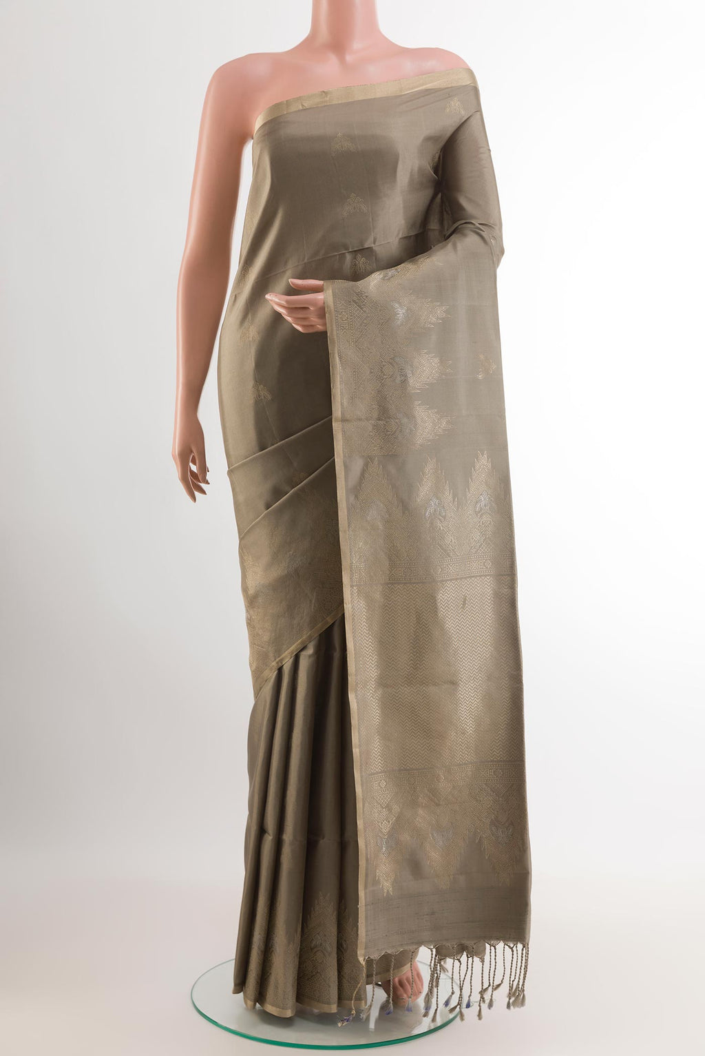 Beige Soft Silk Saree with Zari Butta on the body and Zari Border.  displayed on a mannequin