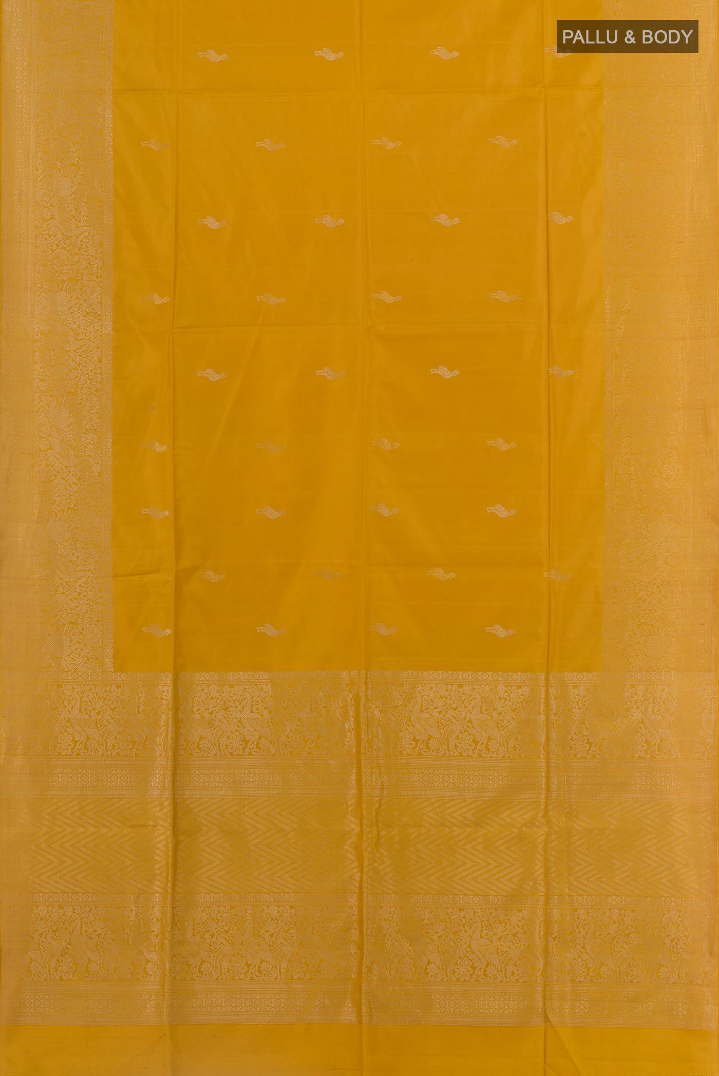 Flat view of Mustard Soft Silk Saree with Zari Butta on the body and Zari Border. 