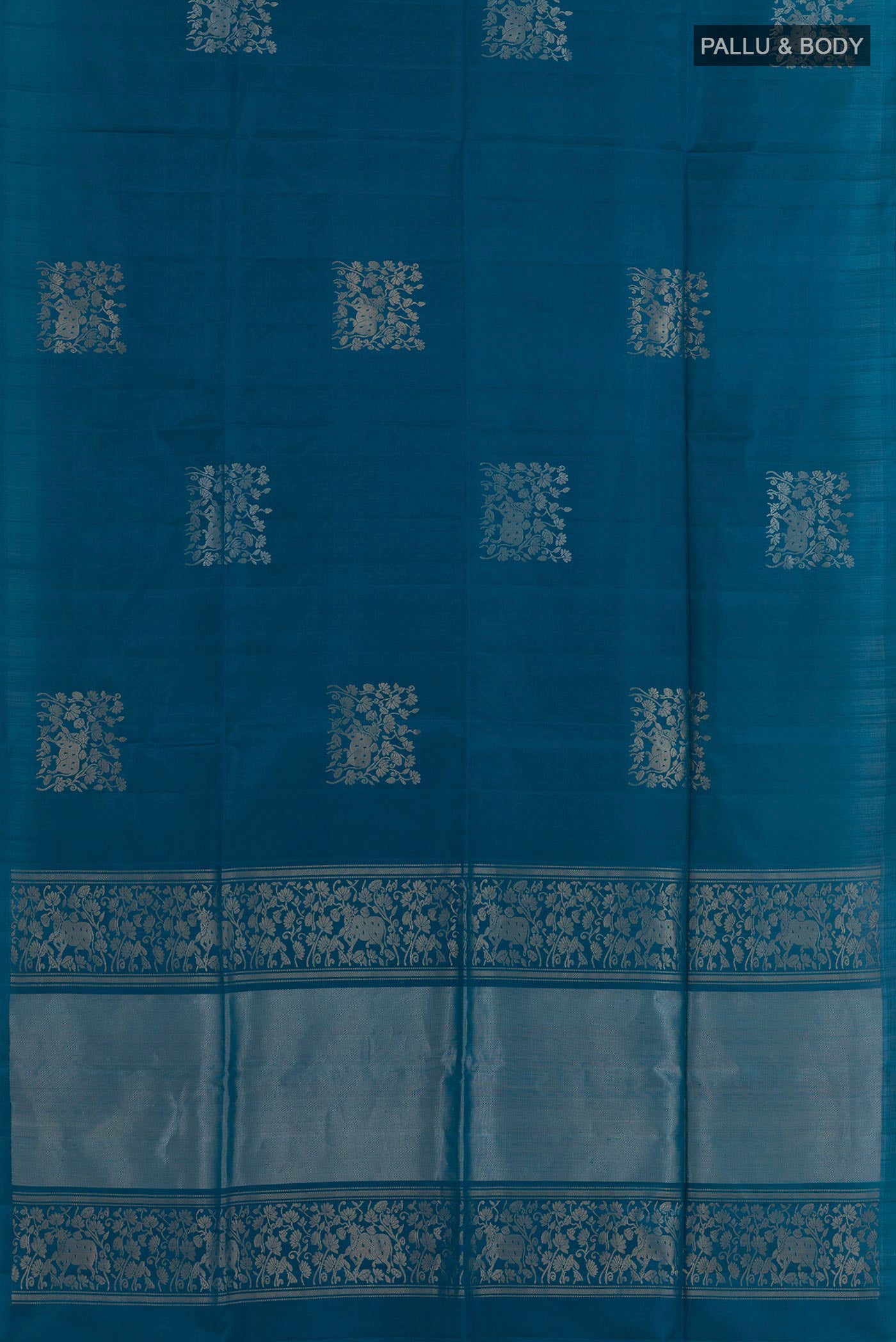 Flat view of Blue Soft Silk Saree with Zari Butta on the body and Zari Border. 