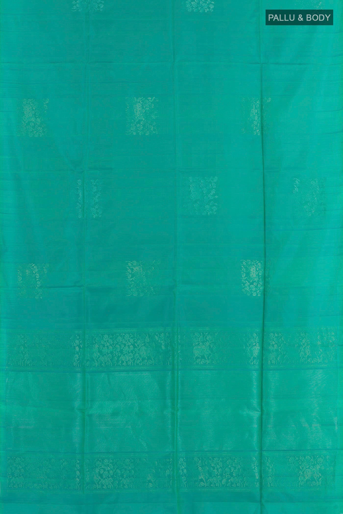 Flat view of Sea Green Soft Silk Saree with Zari Butta on the body and Zari Border. 