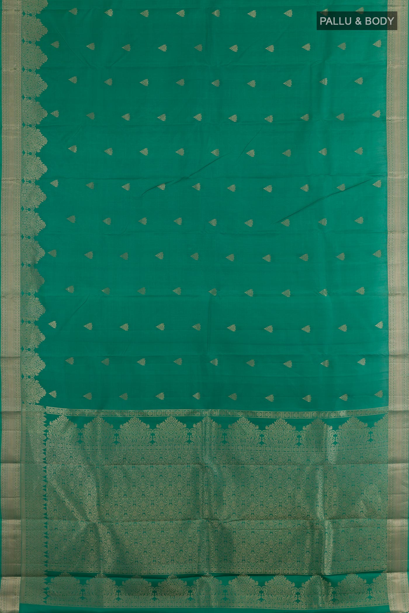Flat view of Green Kanjivaram Silk Saree with Zari Butta on the body and Zari Border. 