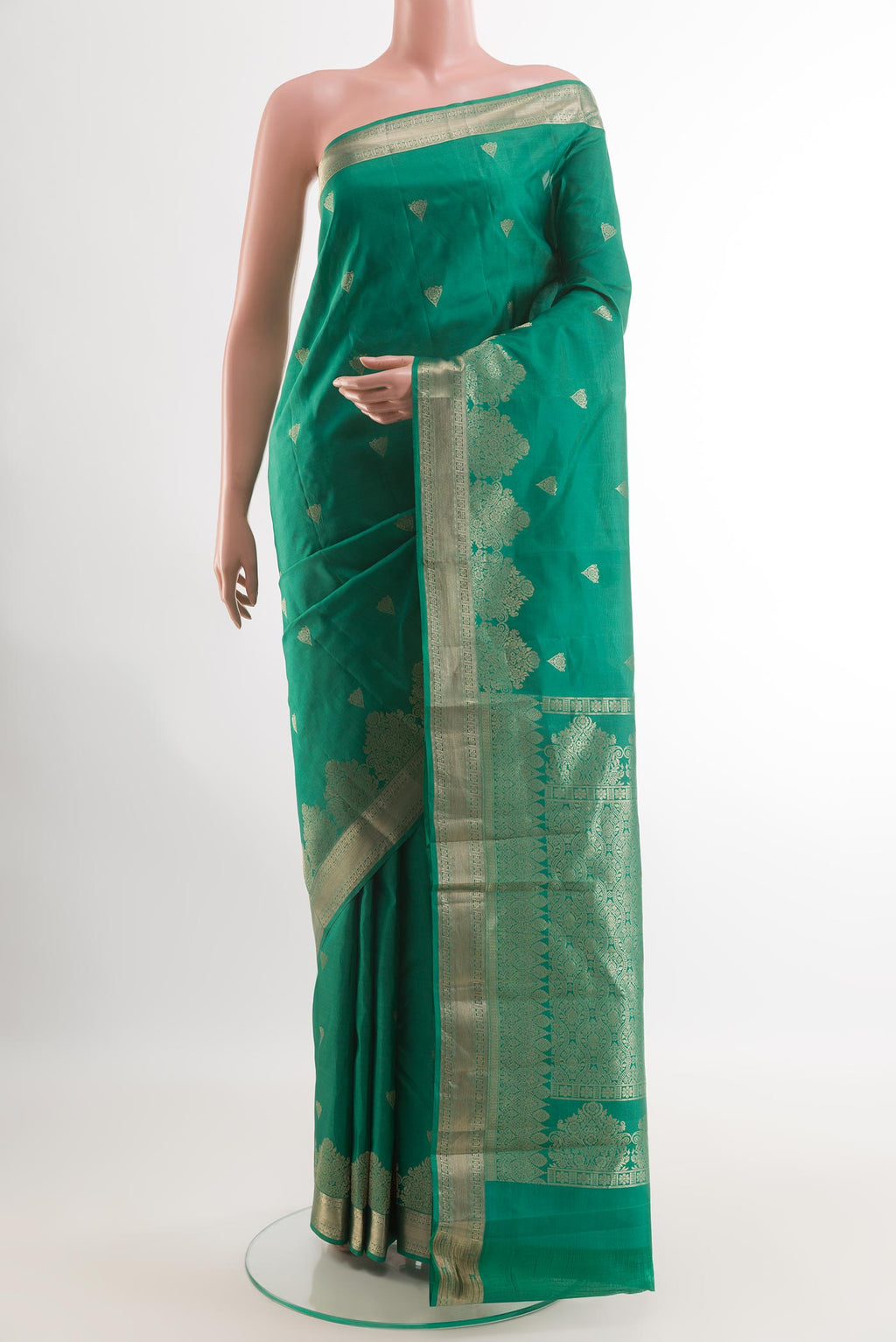 Green Kanjivaram Silk Saree with Zari Butta on the body and Zari Border.  displayed on a mannequin