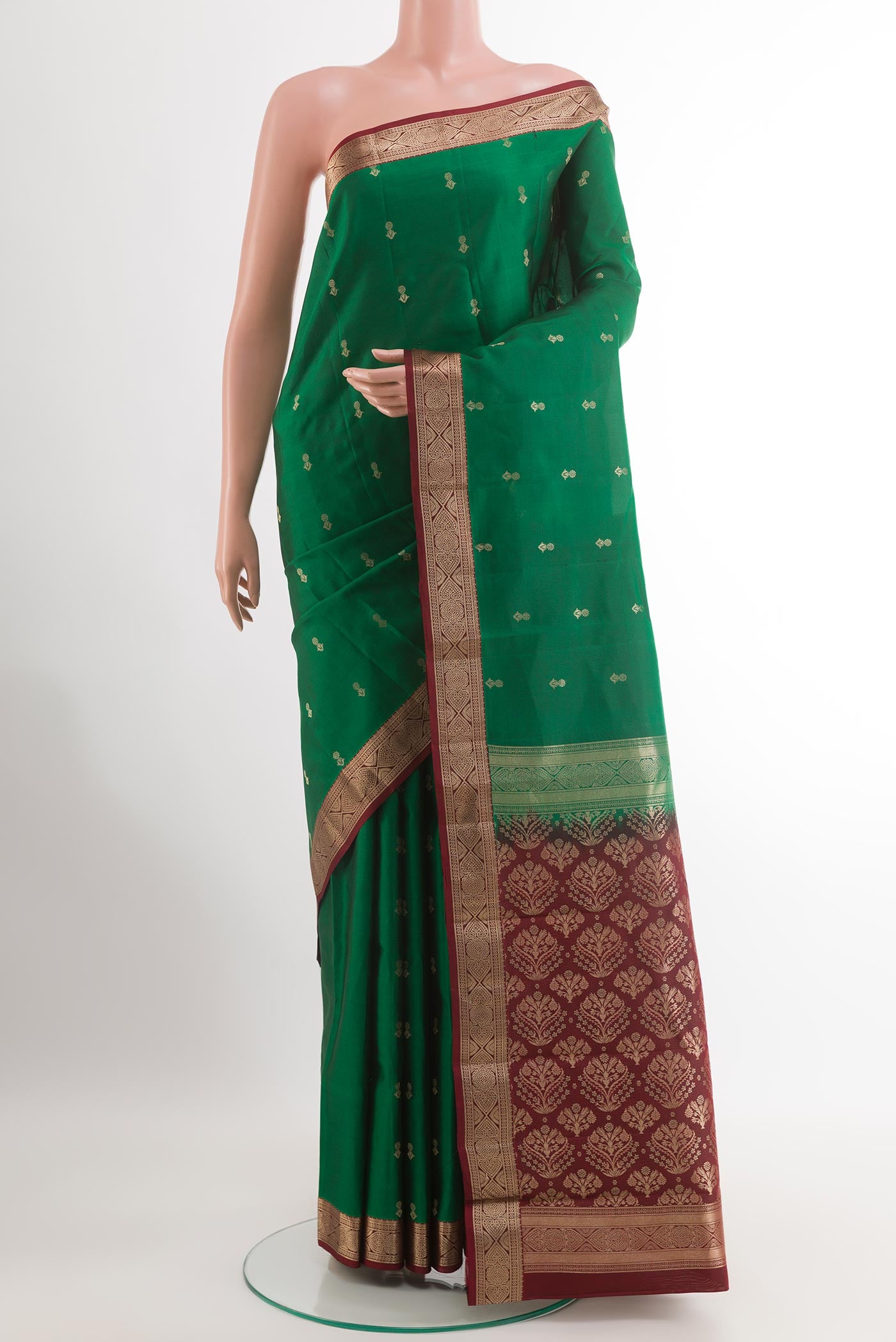 Green Kanchipuram Silk Saree with Zari Butta on the body and Zari Border.  displayed on a mannequin