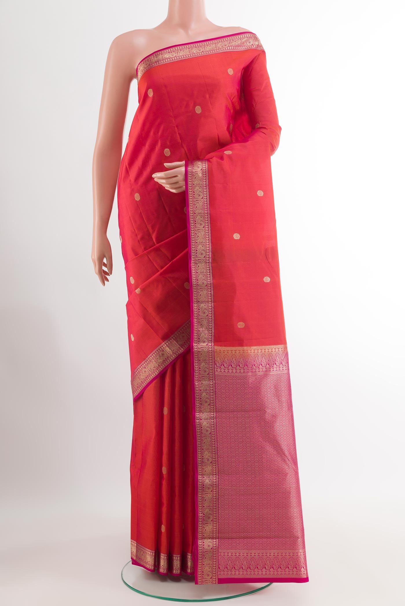 Red Kanchipuram Silk Saree with Zari Butta on the body and Zari Border.  displayed on a mannequin