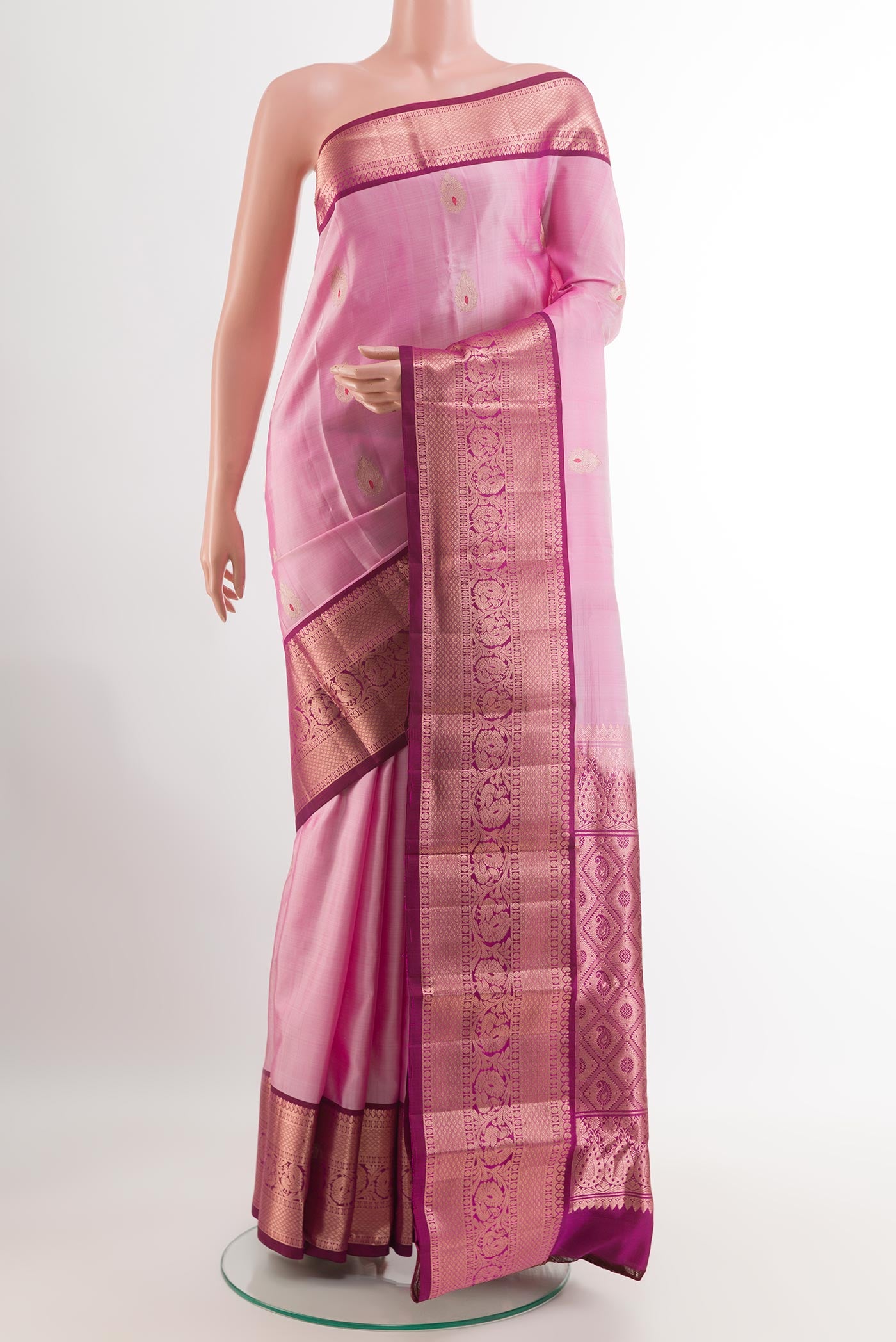 Pink Kanchipuram Silk Saree with Zari Butta on the body and Zari Border.  displayed on a mannequin