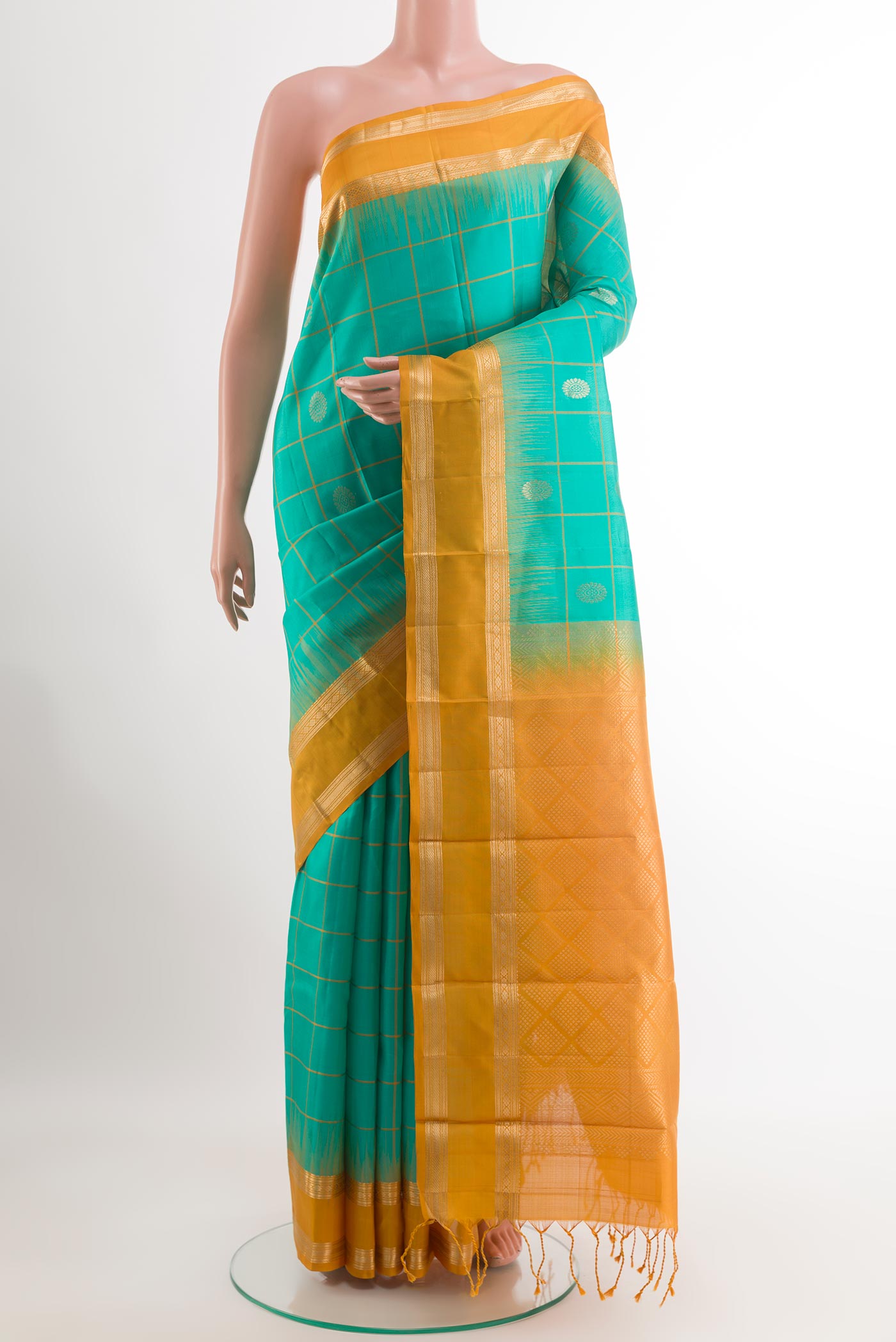 Sea Green Kanjivaram Silk Saree with Checked design on the body and Zari Border.  displayed on a mannequin