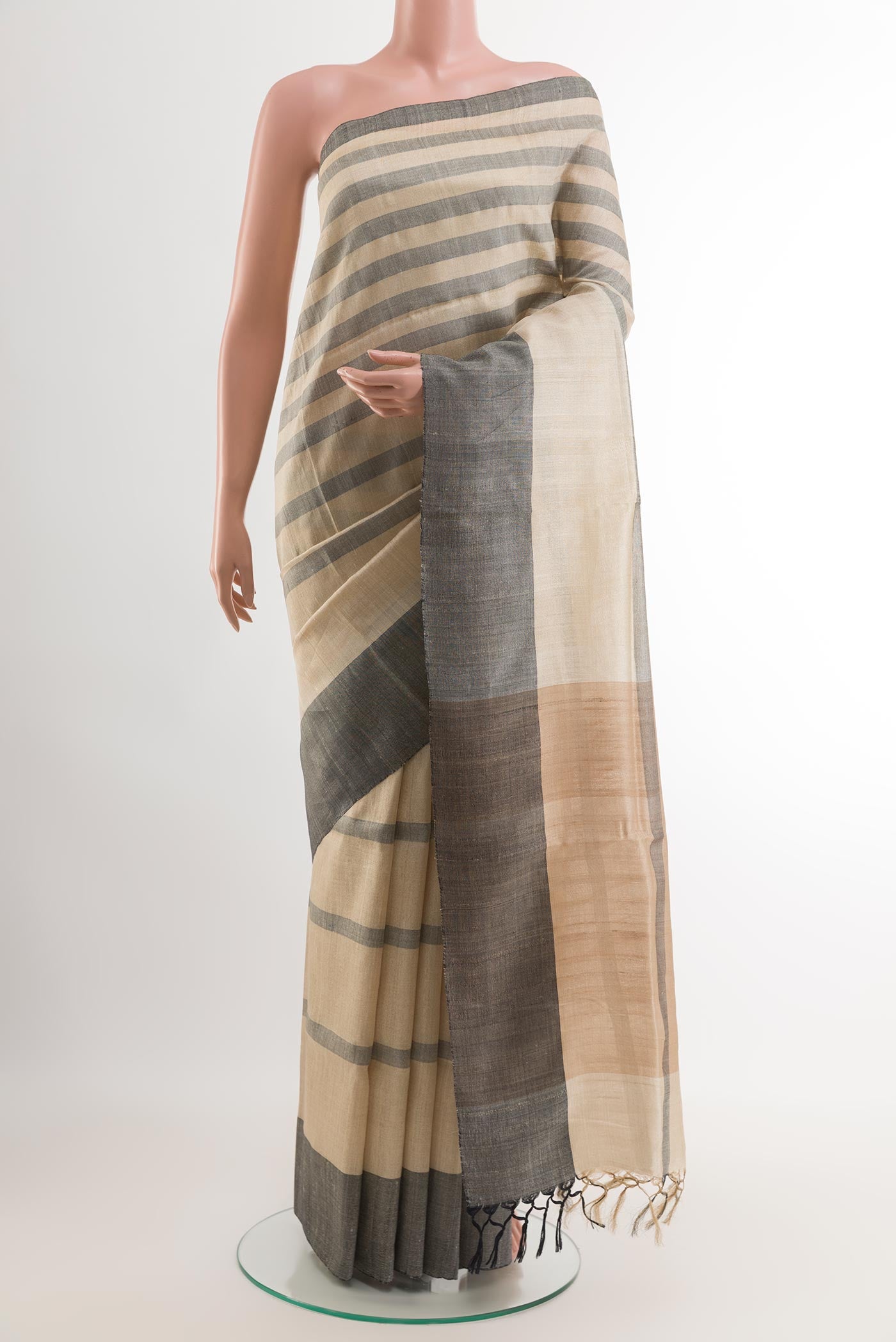 Beige Tussar Saree with Printed design on the body and Without Border.  displayed on a mannequin