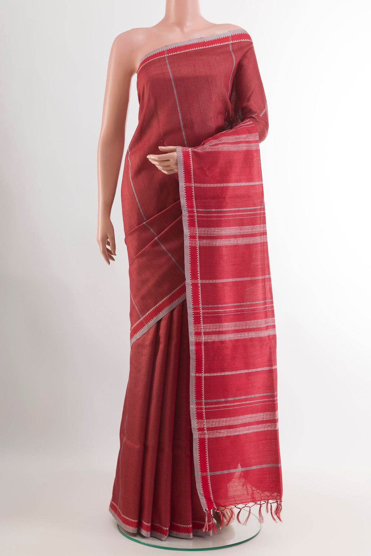 Red Tussar Saree with Stripes on the body and Zari Border.  displayed on a mannequin