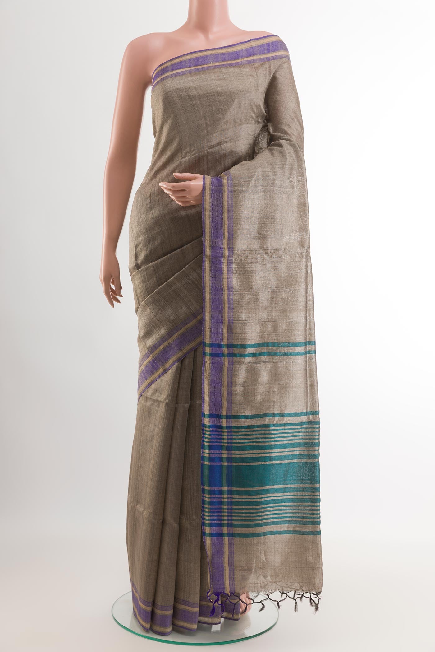 Grey Tussar Saree with Printed design on the body and Without Border.  displayed on a mannequin