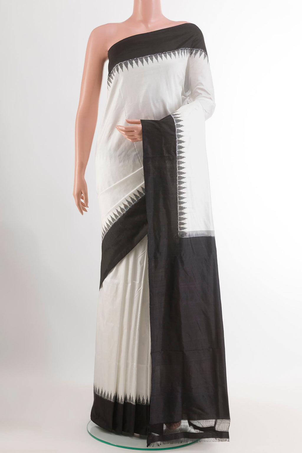 White Pochampally Silk Saree with Ikat design on the body and Zari Border.  displayed on a mannequin