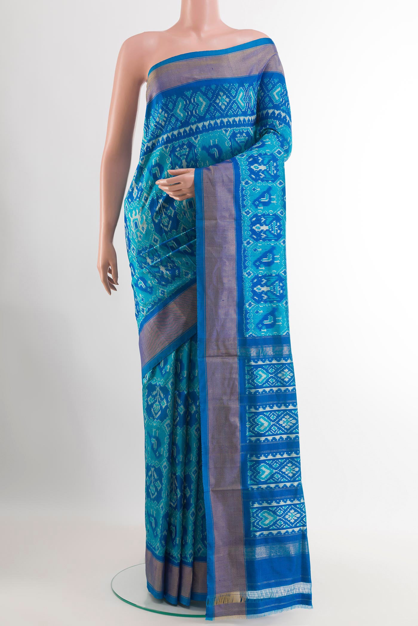 Blue Pochampally Silk Saree with Ikat design on the body and Zari Border.  displayed on a mannequin