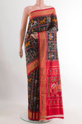Black Pochampally Silk Saree with Pure Ikat on the body and Zari Border.  displayed on a mannequin