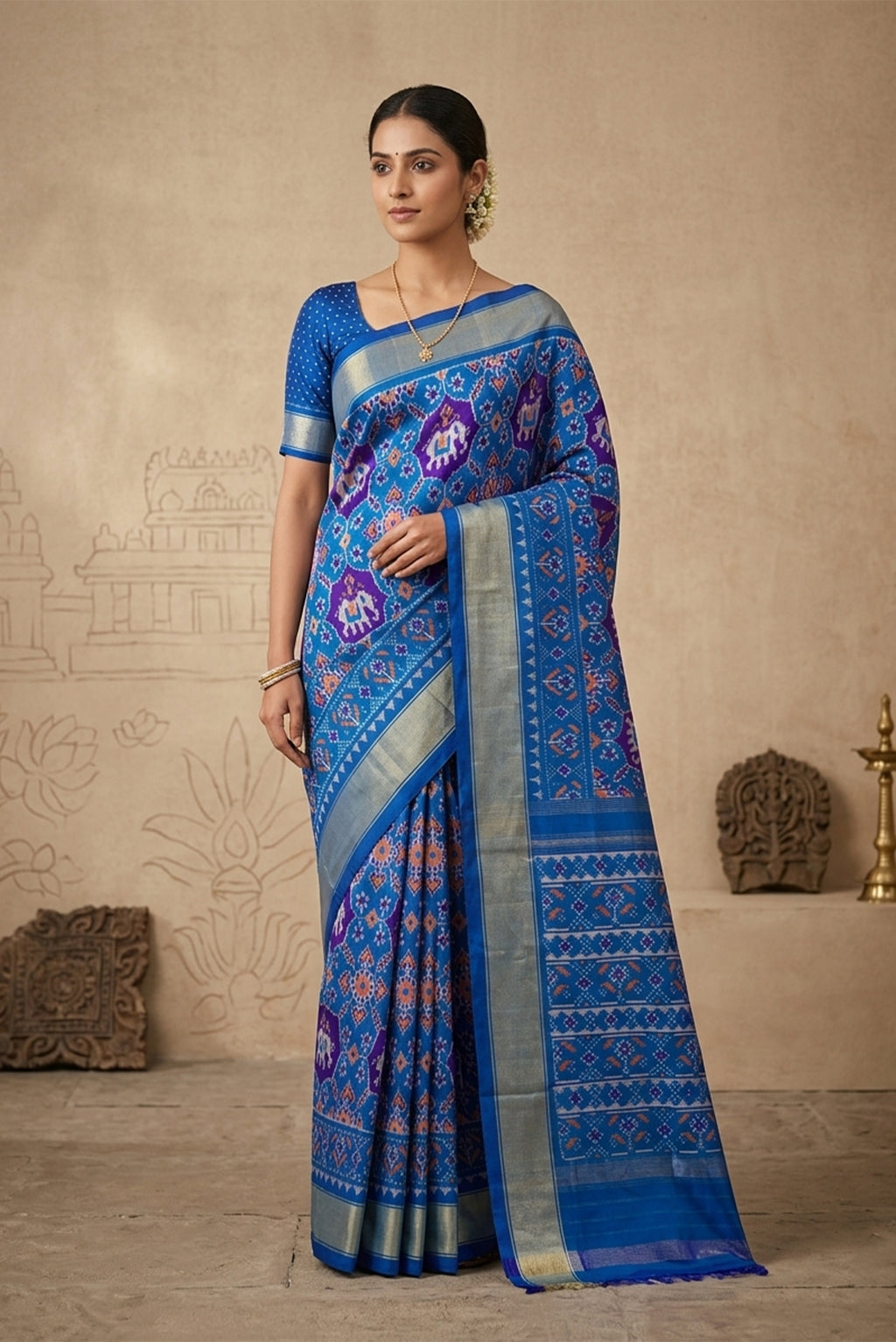 Model wearing a Blue Pochampally Silk Saree with Pure Ikat on the body and Zari Border.