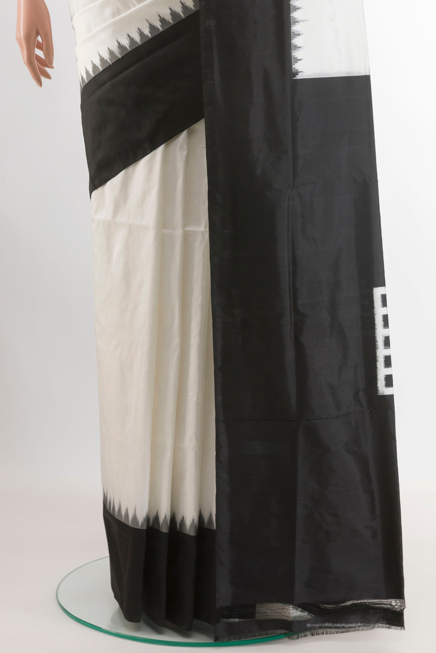 Pleats and pallu of White Pochampally Silk Saree with Ikat design on the body and Zari Border. 