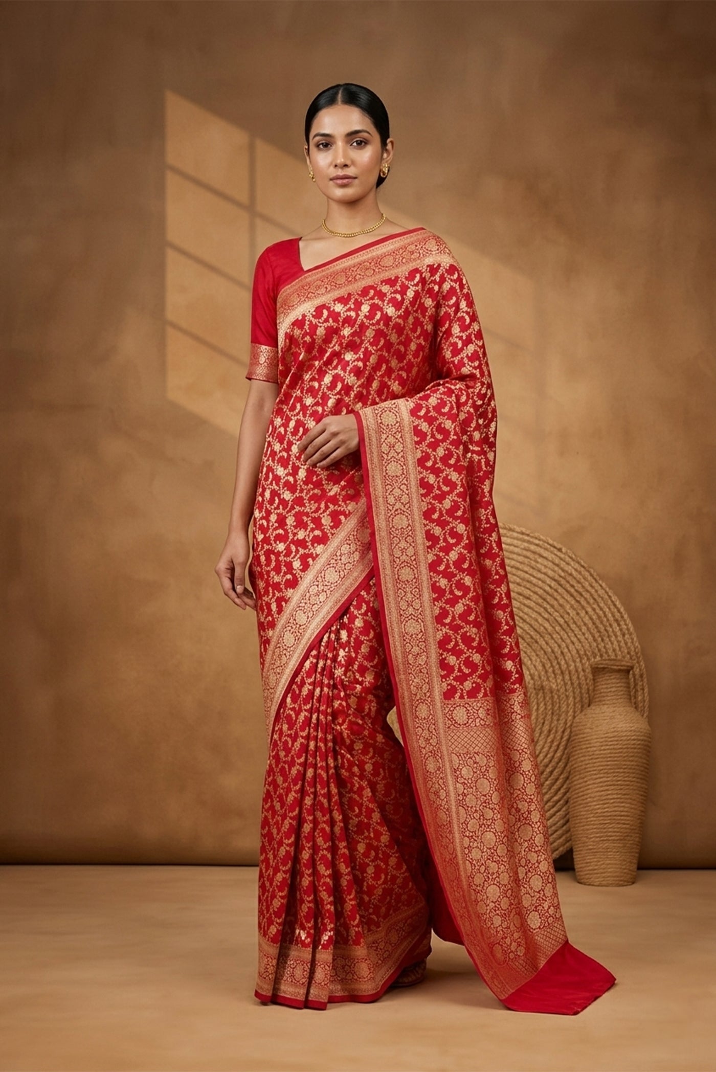 Model wearing a Red Banarasi Silk Saree with Zari Brocade on the body and Zari Border.