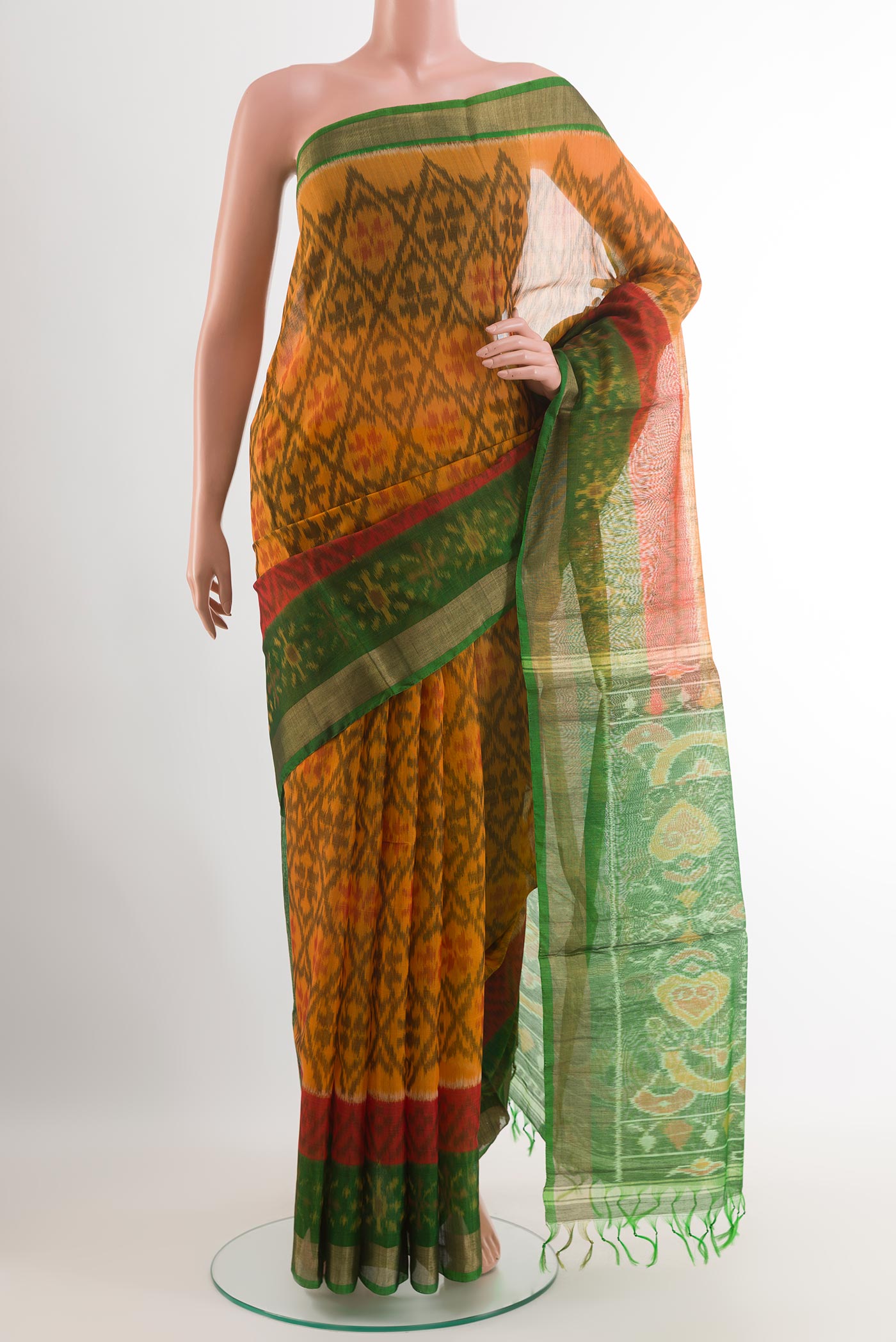 Mustard Blended Kora Cotton Saree with Ikat design on the body and Zari Border.  displayed on a mannequin