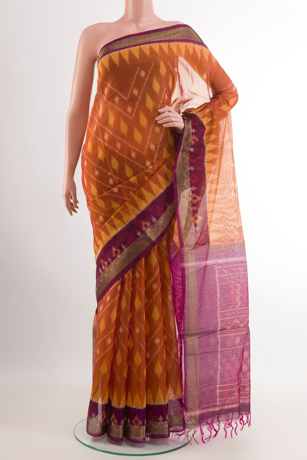 Mustard Blended Kora Cotton Saree with Ikat design on the body and Zari Border.  displayed on a mannequin