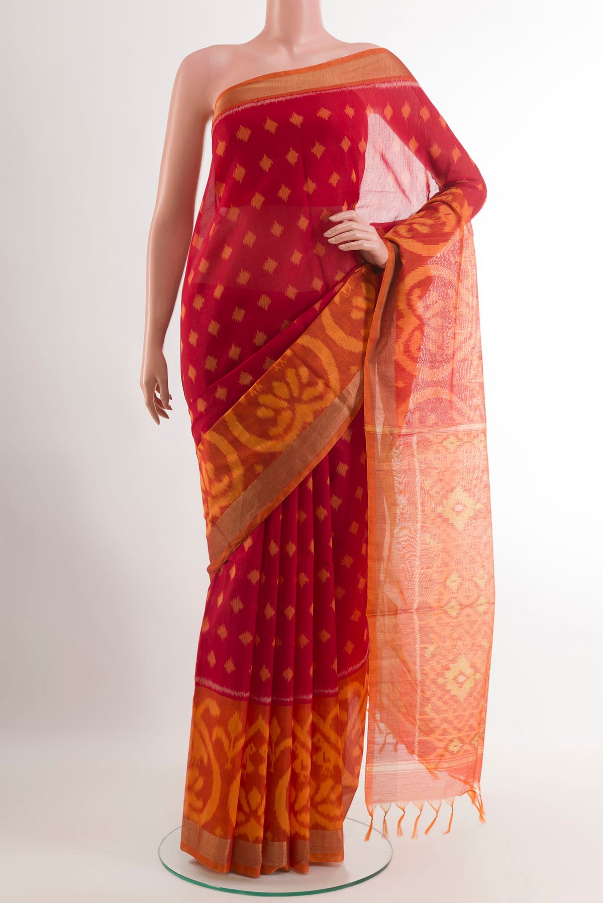 Red Blended Kora Cotton Saree with Ikat design on the body and Zari Border.  displayed on a mannequin