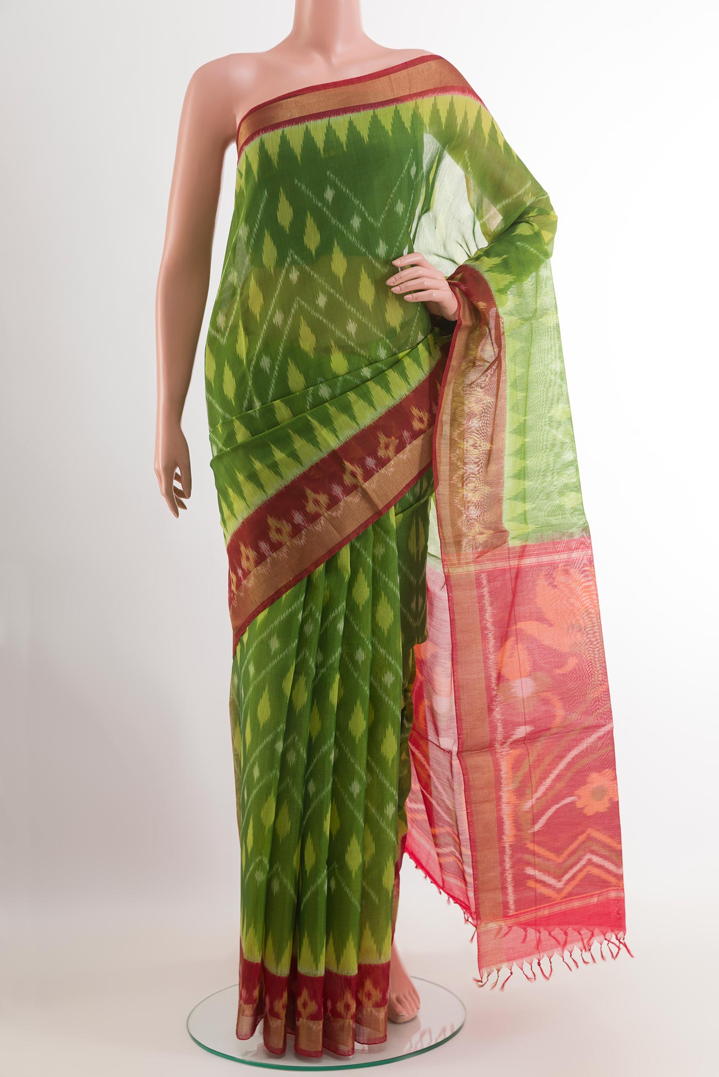 Green Blended Kora Cotton Saree with Ikat design on the body and Zari Border.  displayed on a mannequin