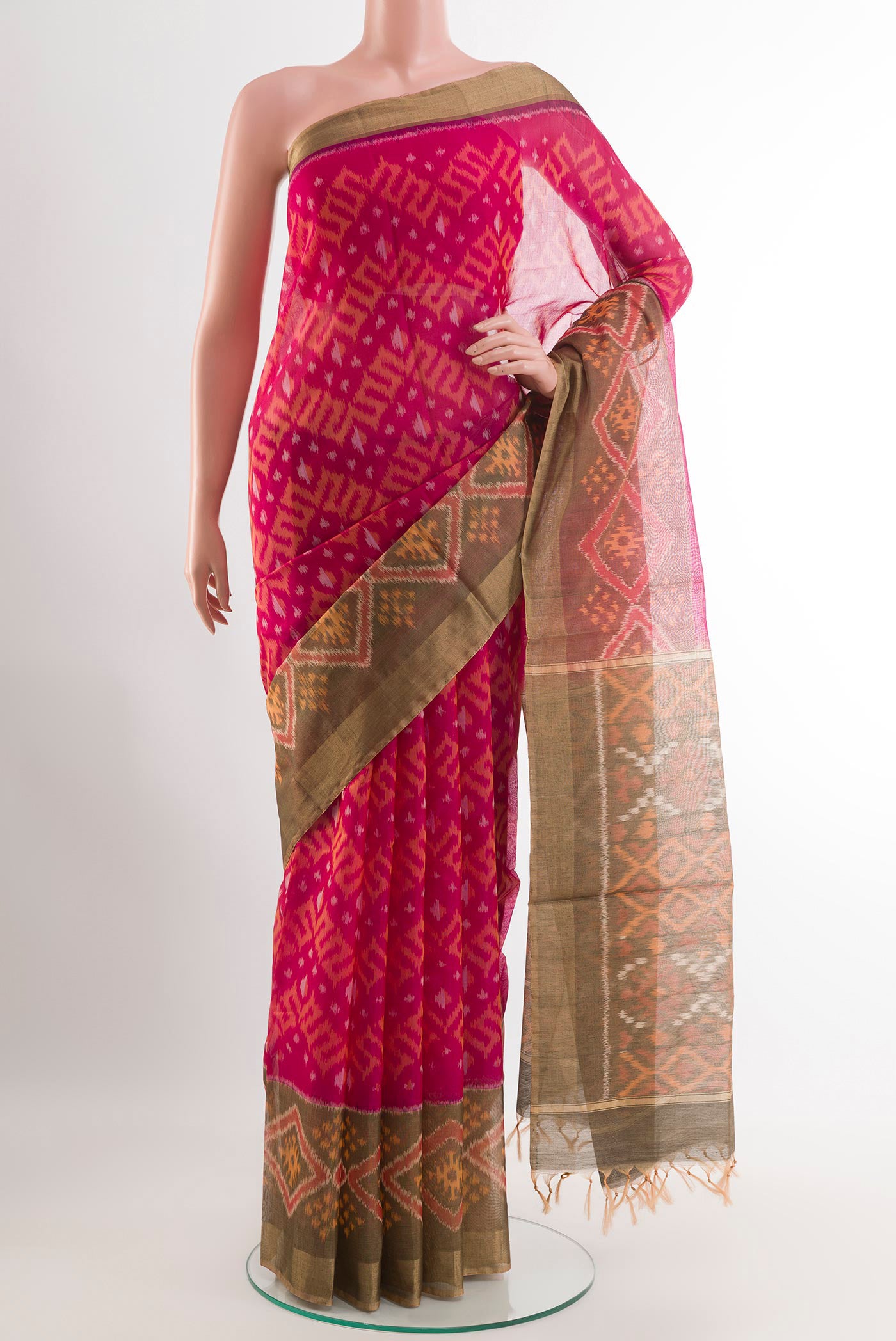 Pink Kora Cotton Saree with Ikat design on the body and Zari Border.  displayed on a mannequin