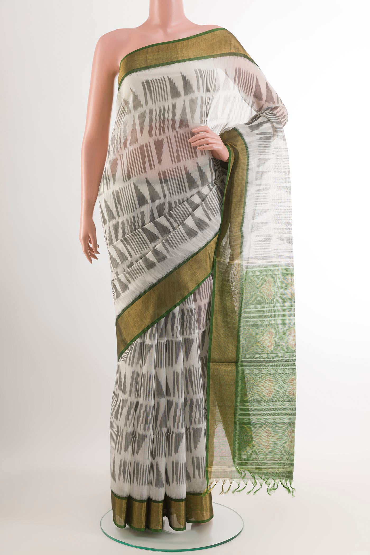 Off White Blended Kora Cotton Saree with Ikat design on the body and Zari Border.  displayed on a mannequin
