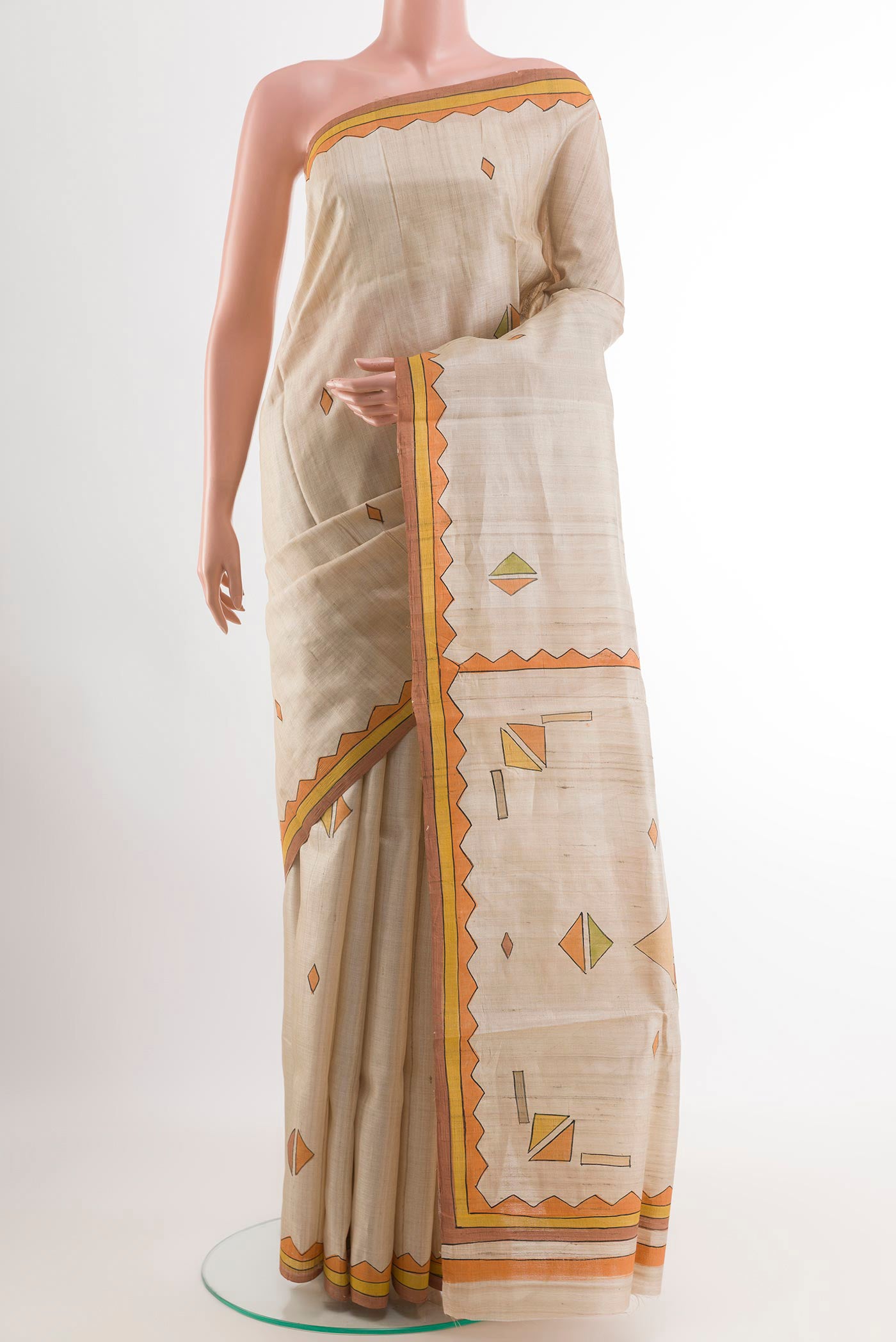Cream Tussar Saree with Printed design on the body and Printed Border.  displayed on a mannequin