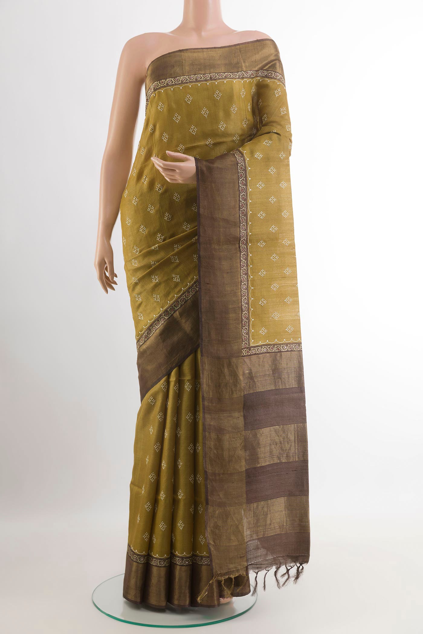 Yellow Tussar Saree with Thread Butta on the body and Zari Border.  displayed on a mannequin