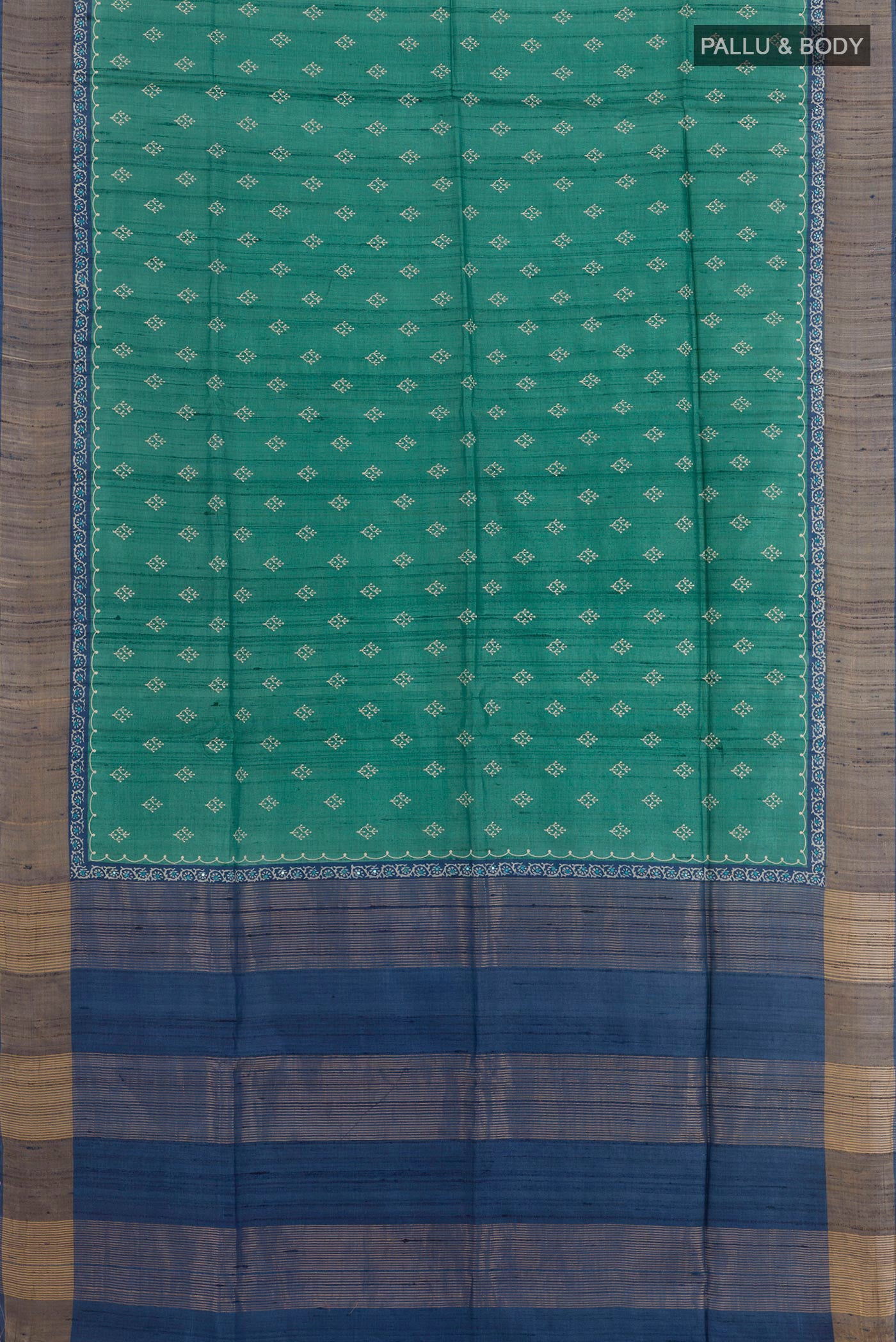 Flat view of Green Tussar Saree with Thread Butta on the body and Zari Border. 