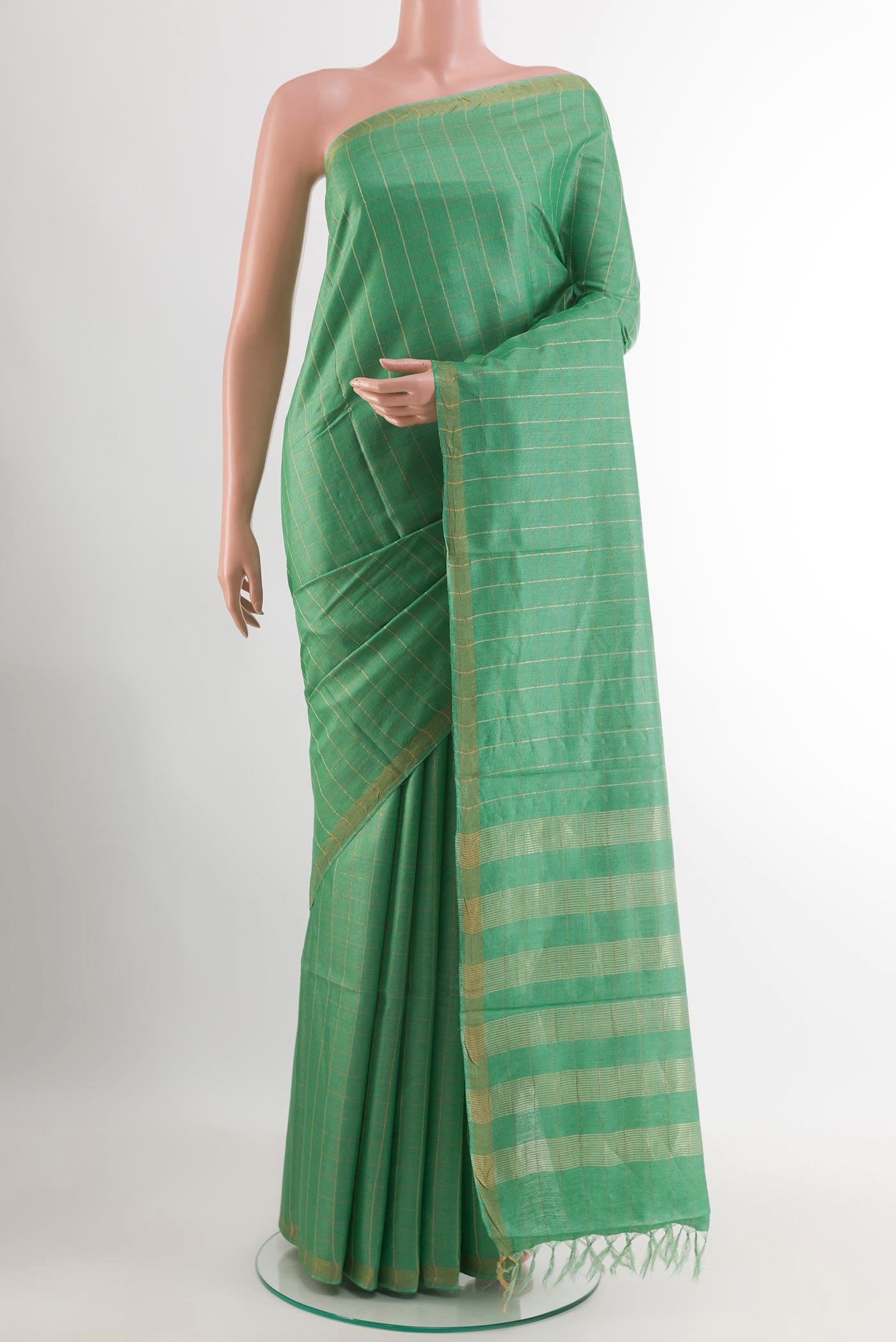 Green Tussar Saree with Checked design on the body and Zari Border.  displayed on a mannequin