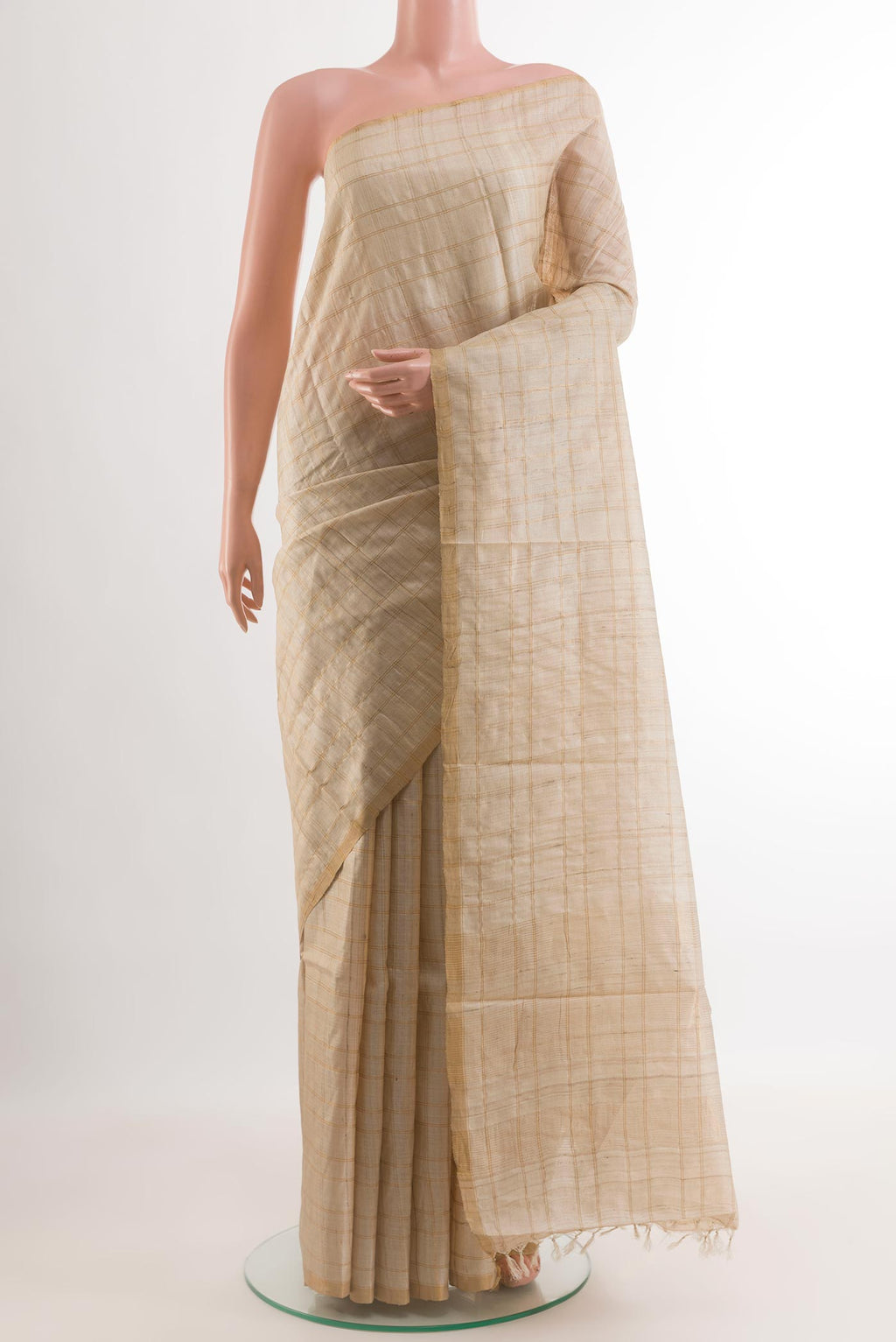 Cream Tussar Silk Saree with Checked design on the body and Zari Border.  displayed on a mannequin