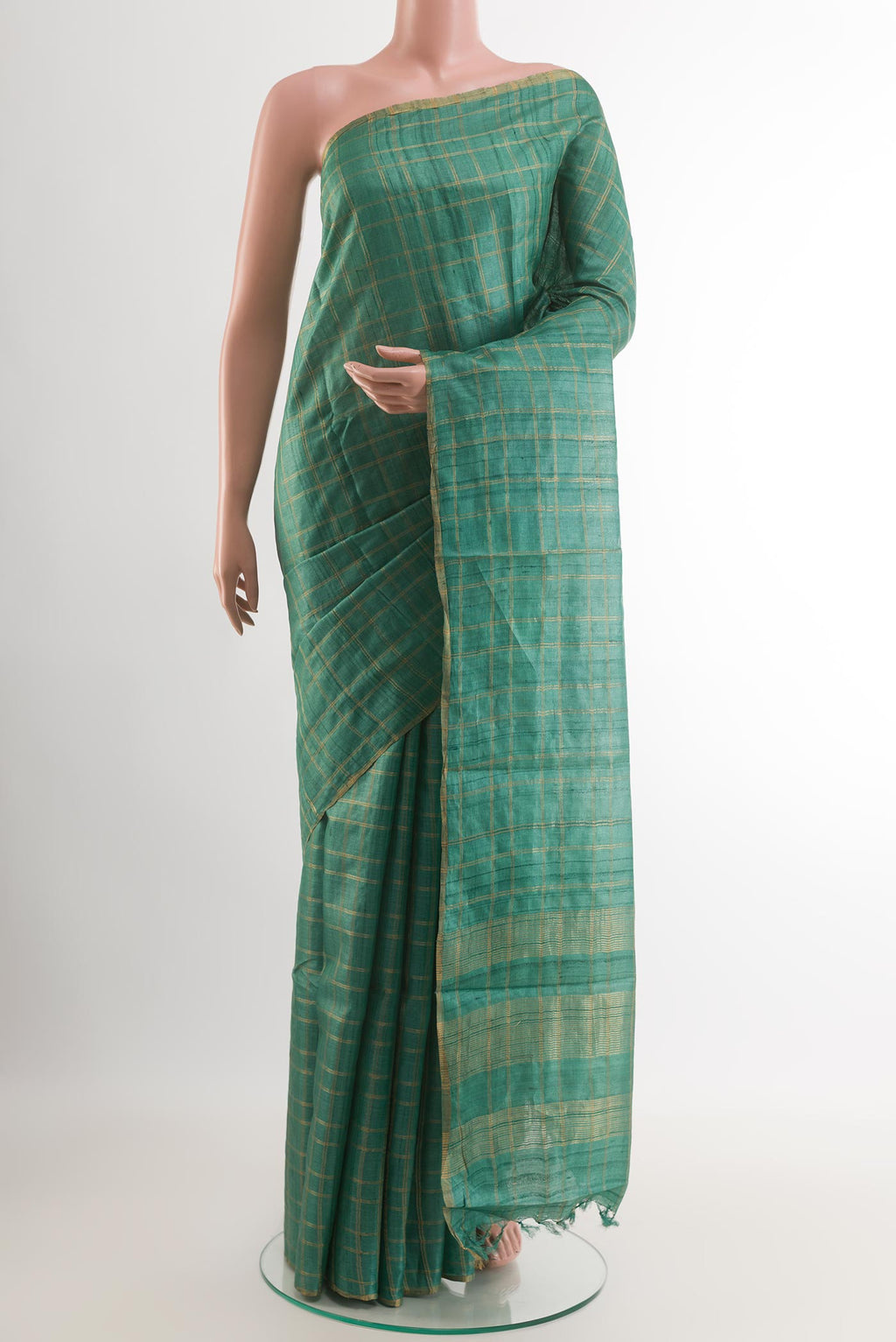 Green Tussar Saree with Checked design on the body and Zari Border.  displayed on a mannequin