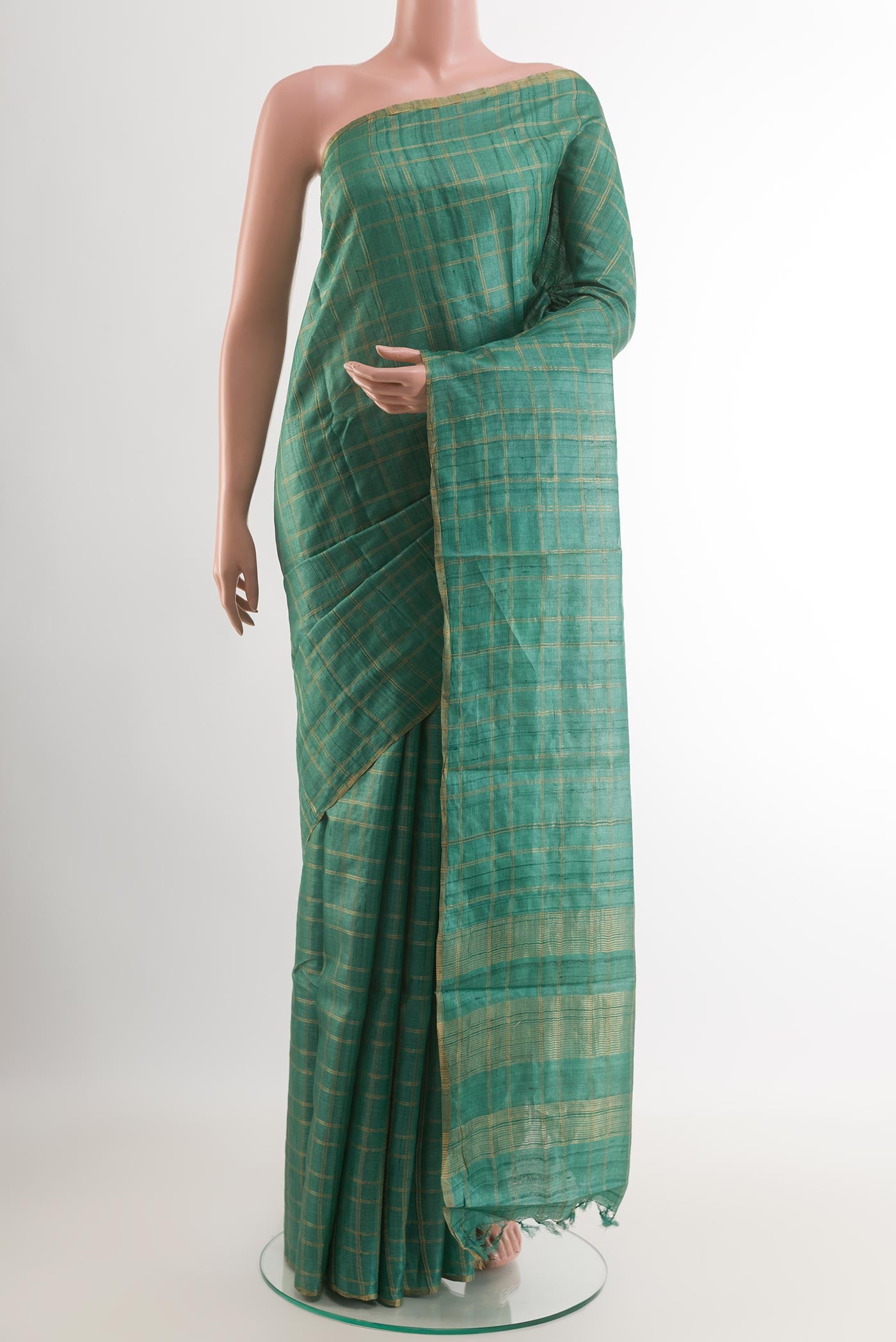 Green Tussar Saree with Checked design on the body and Zari Border.  displayed on a mannequin