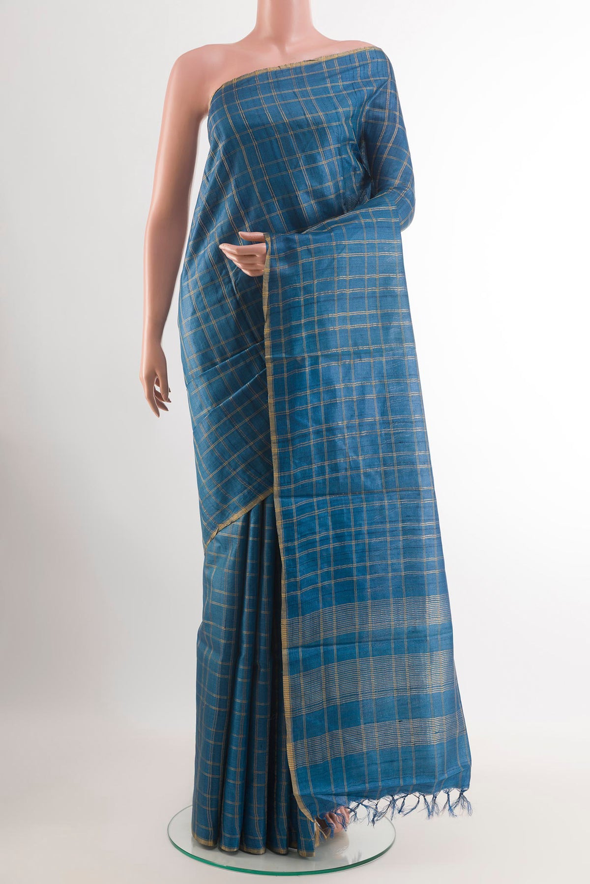 Blue Tussar Saree with Checked design on the body and Zari Border.  displayed on a mannequin