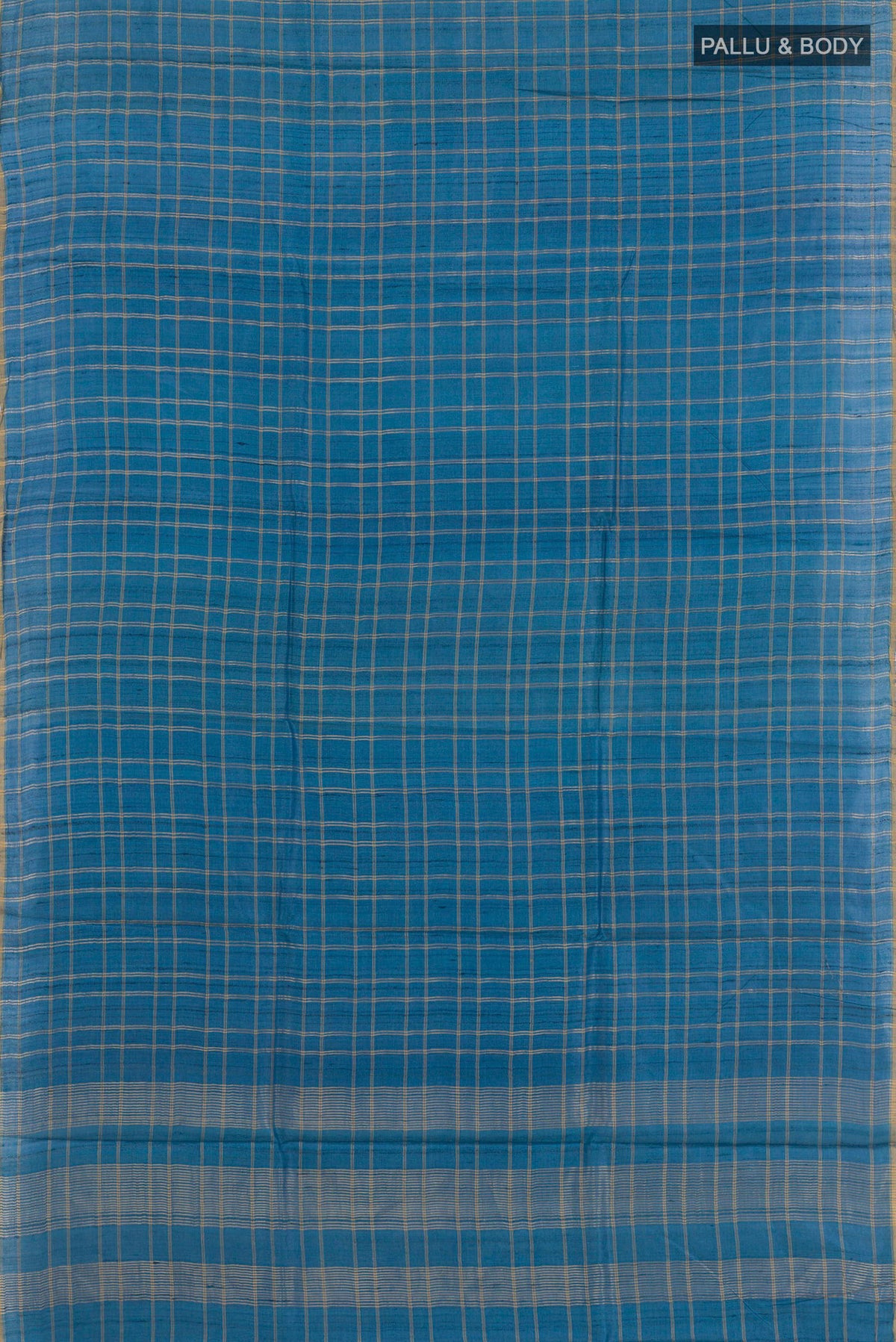 Flat view of Blue Tussar Saree with Checked design on the body and Zari Border. 