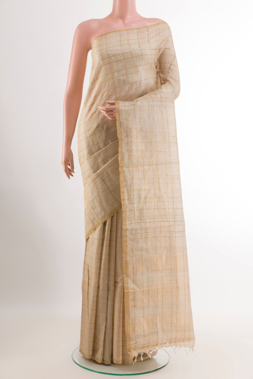 Off White Tussar Saree with Checked design on the body and Zari Border.  displayed on a mannequin