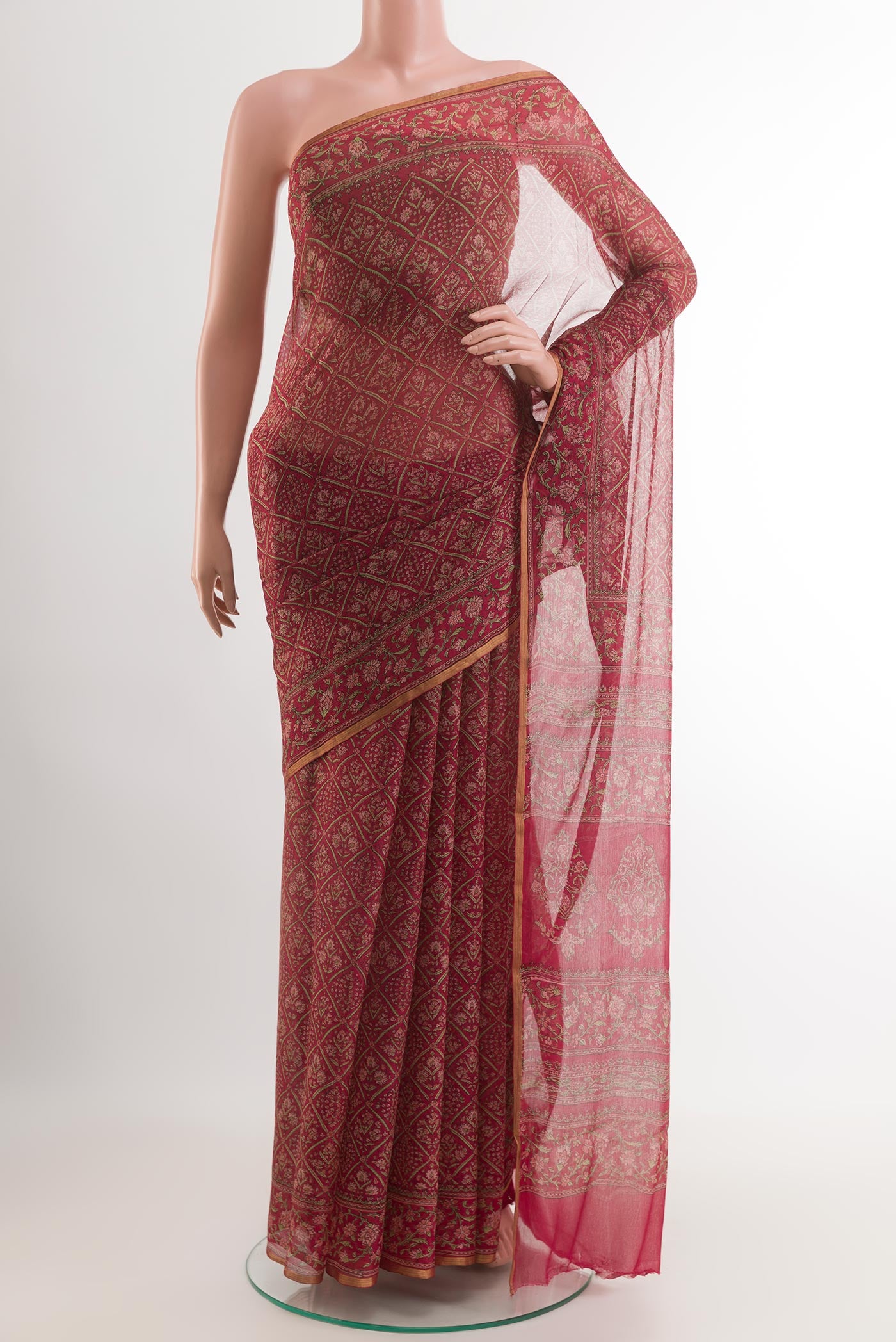 Red Chiffon Saree with Printed design on the body and Printed Border.  displayed on a mannequin