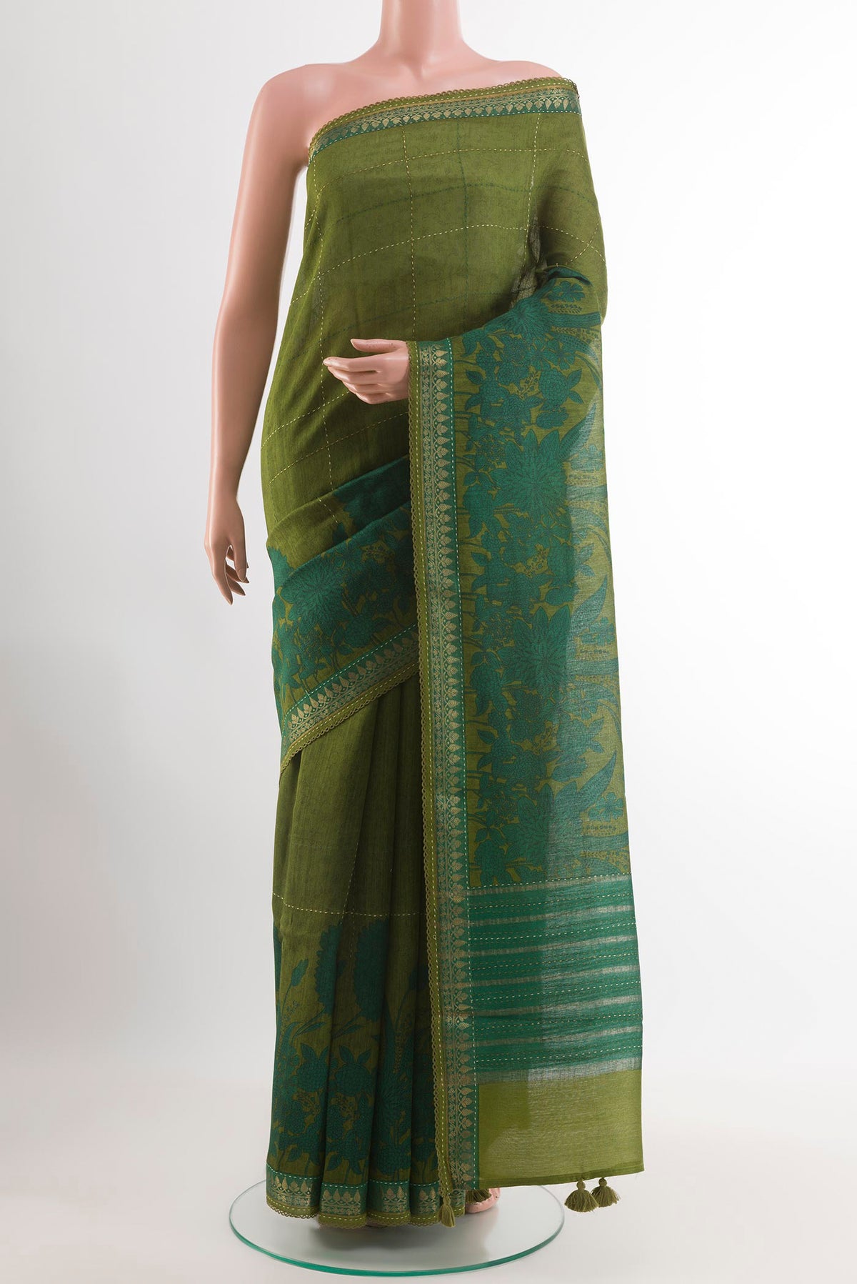 Green Tussar Saree with Checked design on the body and Zari Border.  displayed on a mannequin