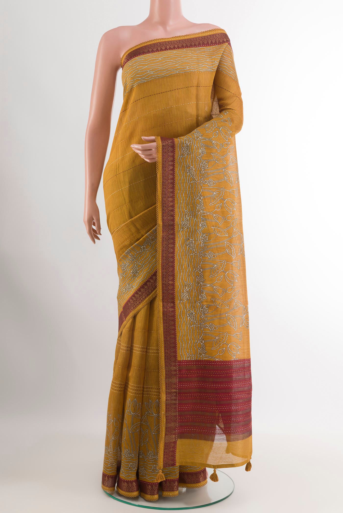 Yellow Tussar Saree with Printed design on the body and Zari Border.  displayed on a mannequin