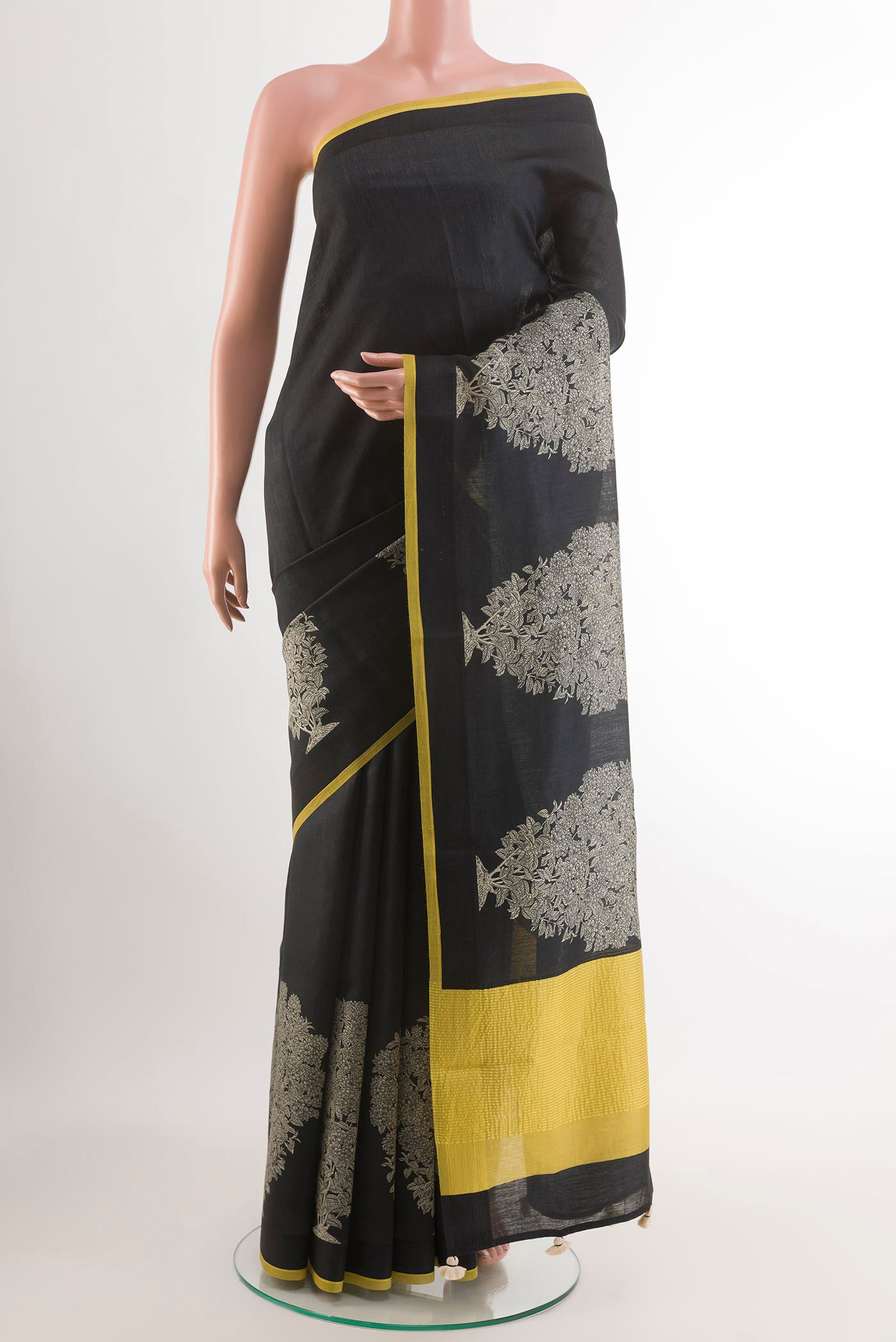 Black Tussar Saree with Printed design on the body and Thread Embroidery Border.  displayed on a mannequin