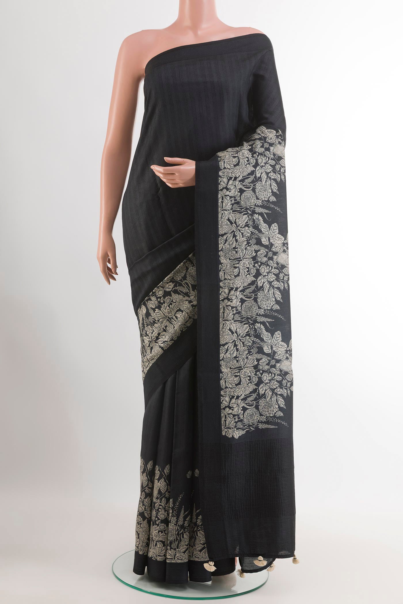 Black Tussar Saree with Printed design on the body and Thread Embroidery Border.  displayed on a mannequin