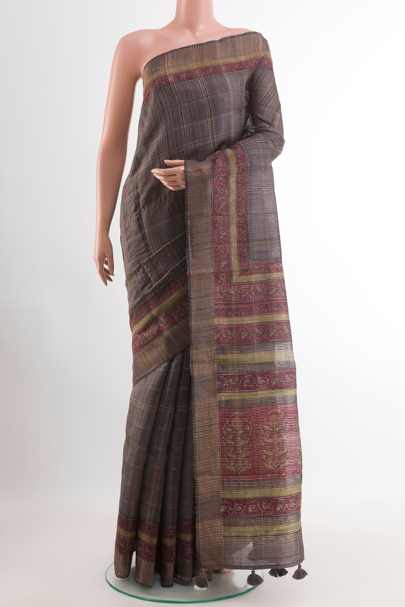 Grey Tussar Saree with Checked design on the body and Zari Border.  displayed on a mannequin