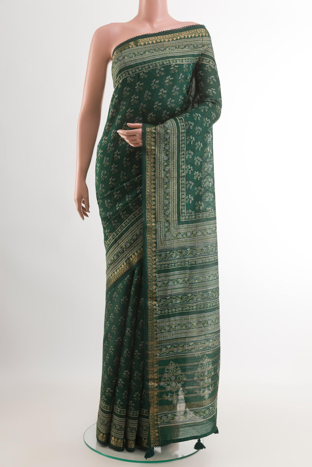 Green Tussar Saree with Printed design on the body and Zari Border.  displayed on a mannequin