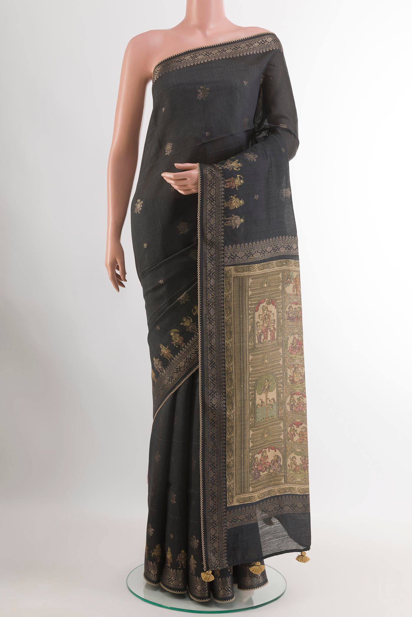 Black Tussar Saree with Zari Butta on the body and Zari Border.  displayed on a mannequin