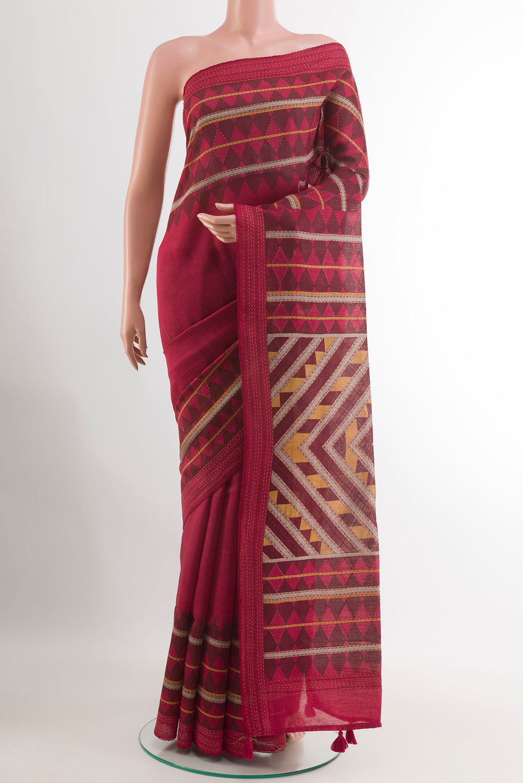 Red Tussar Saree with Printed design on the body and Thread Embroidery Border.  displayed on a mannequin