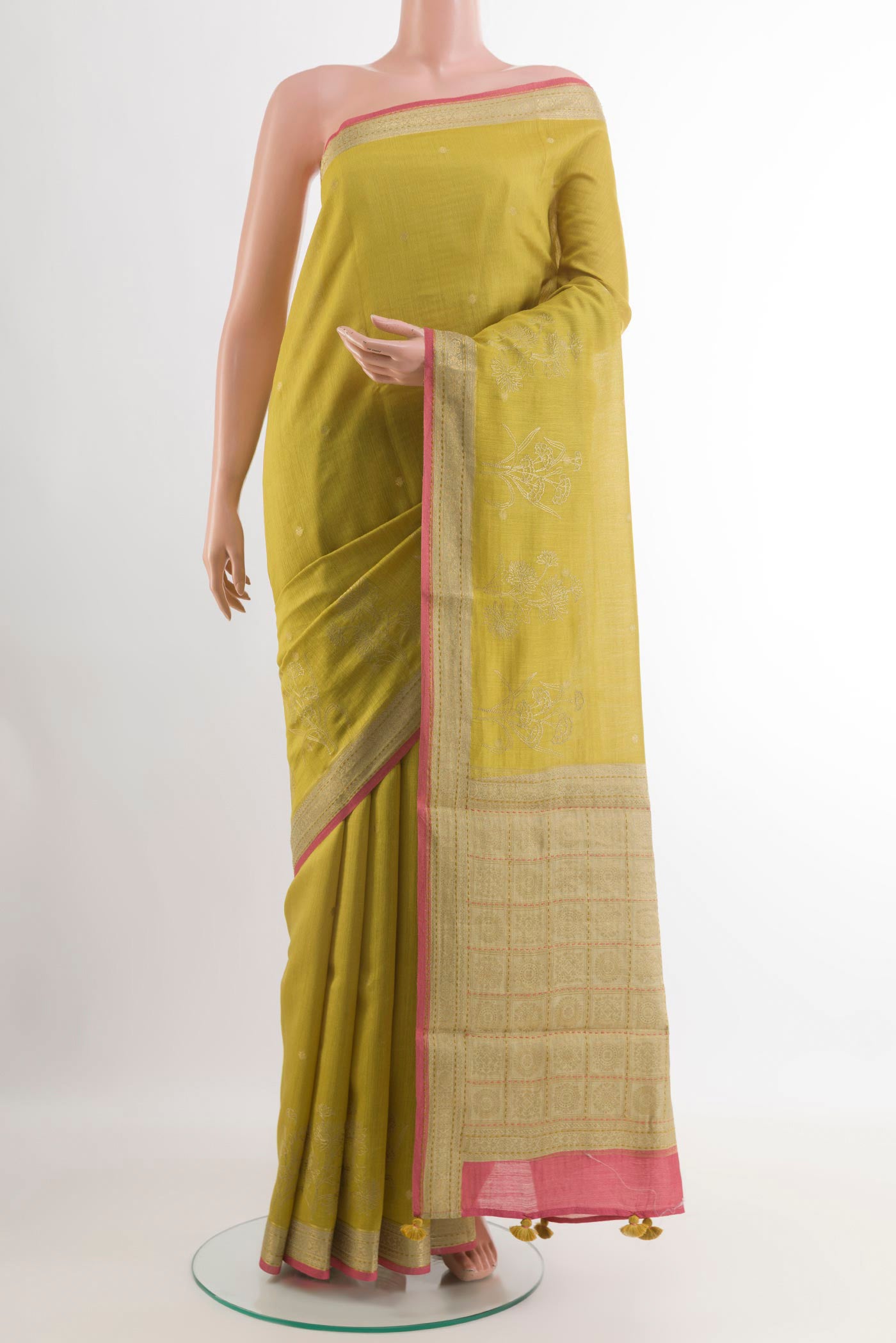 Yellow Tussar Saree with Zari Butta on the body and Zari Border.  displayed on a mannequin